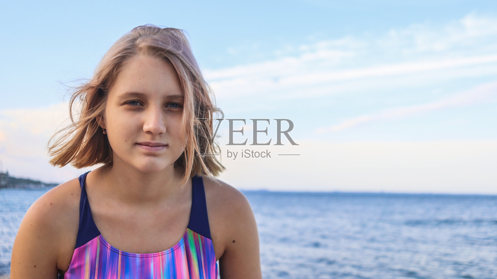 一个年轻的十几岁的女孩的肖像，以夏天的大海为背景照片摄影图片