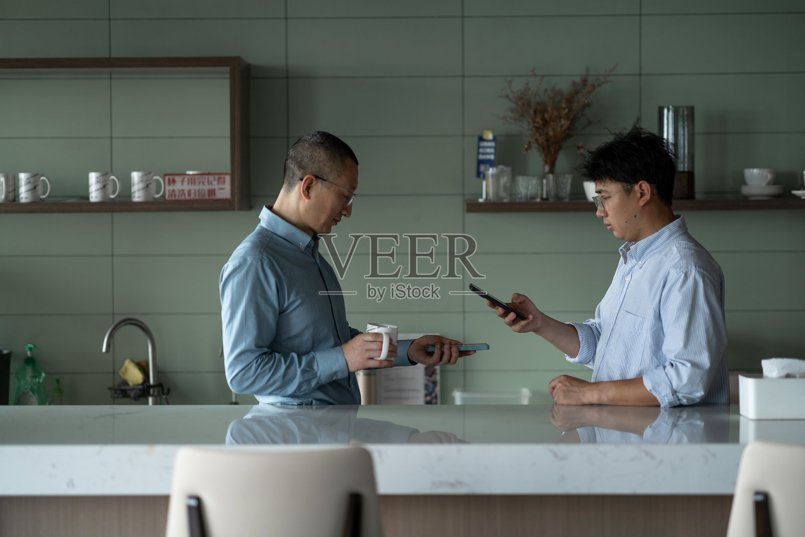 商务人士在茶水间讨论照片摄影图片