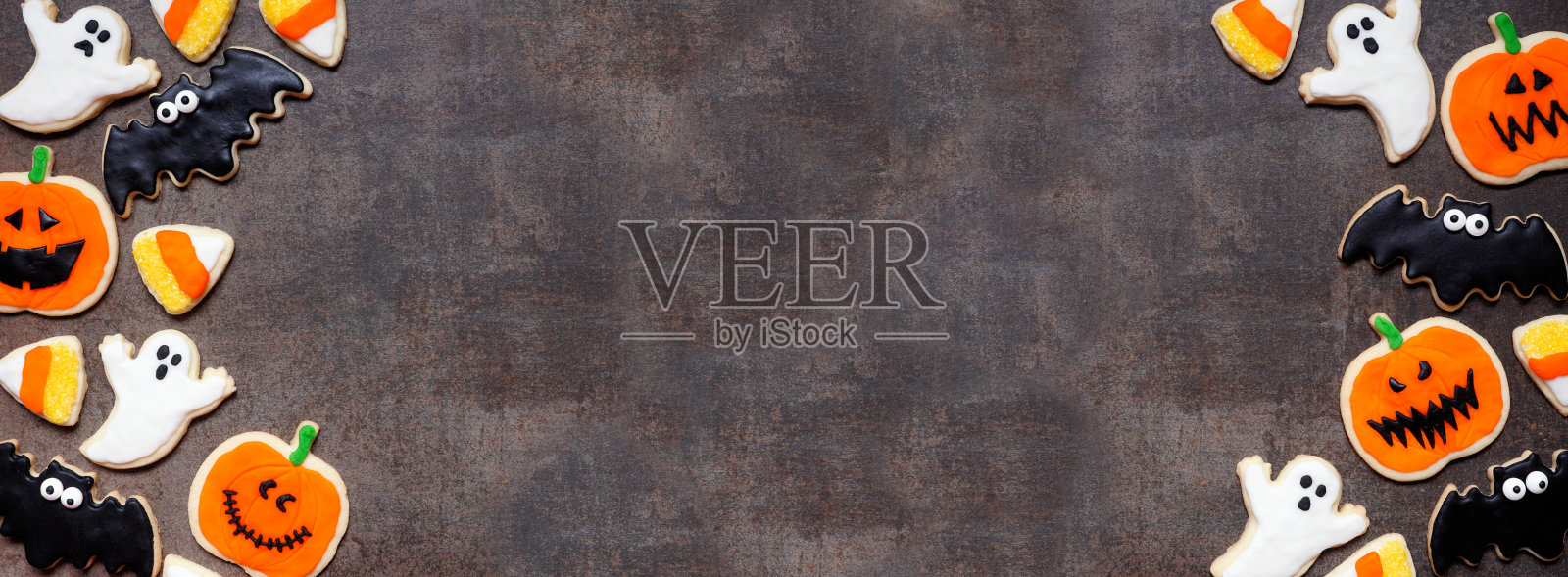 万圣节饼干双边框在一个黑暗的石头横幅背景照片摄影图片