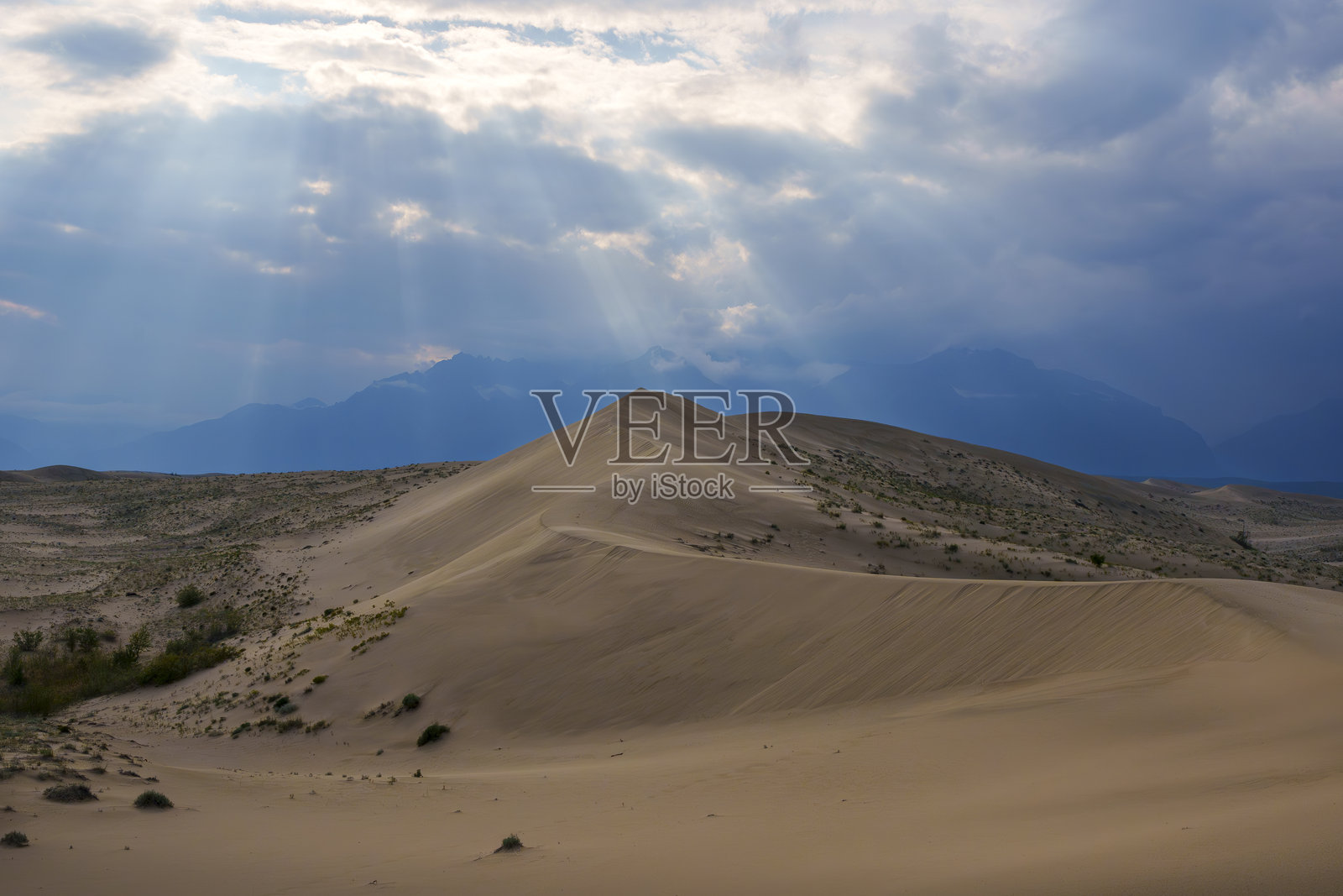 阳光和多云的天空下壮观的沙漠沙丘照片摄影图片