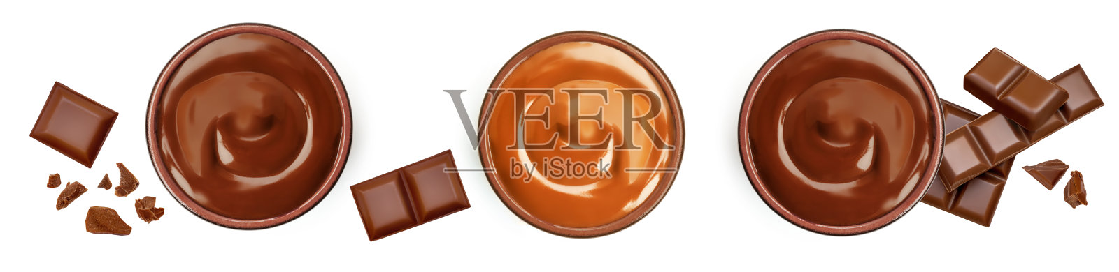 在碗里融化的黑巧克力，焦糖酱和破碎的巧克力块被隔离在白色背景上，俯视图。平躺照片摄影图片