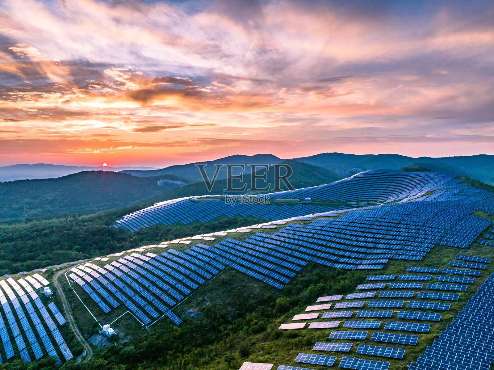 航拍山坡上光伏太阳能发电站照片摄影图片