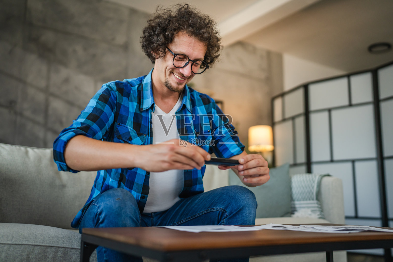 成年白人男性在家用手机进行非接触式支付照片摄影图片