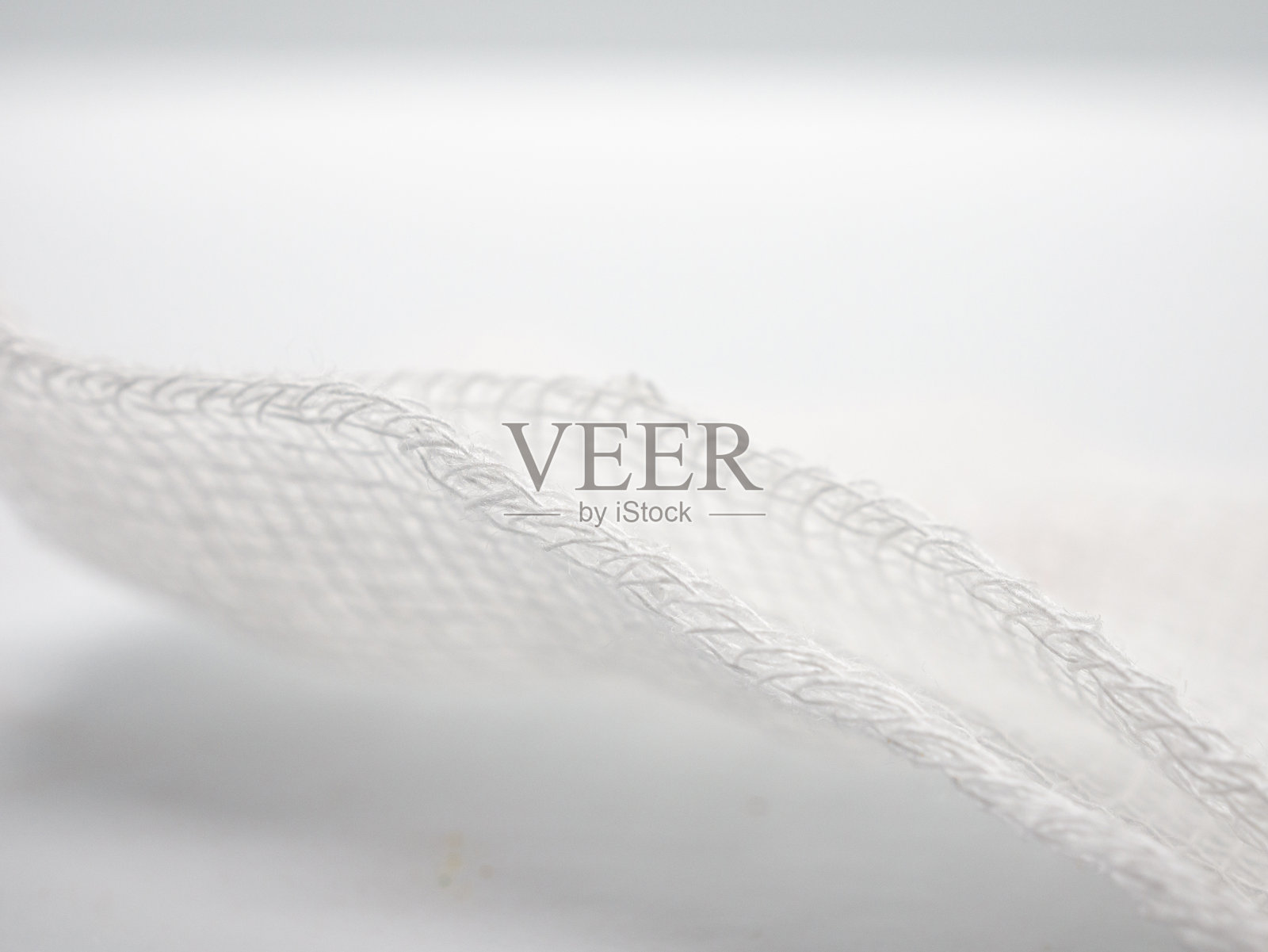 特写白色医用绷带的细节和纹理编织图案背景，微距照片细节的绷带编织纤维，壁纸照片摄影图片