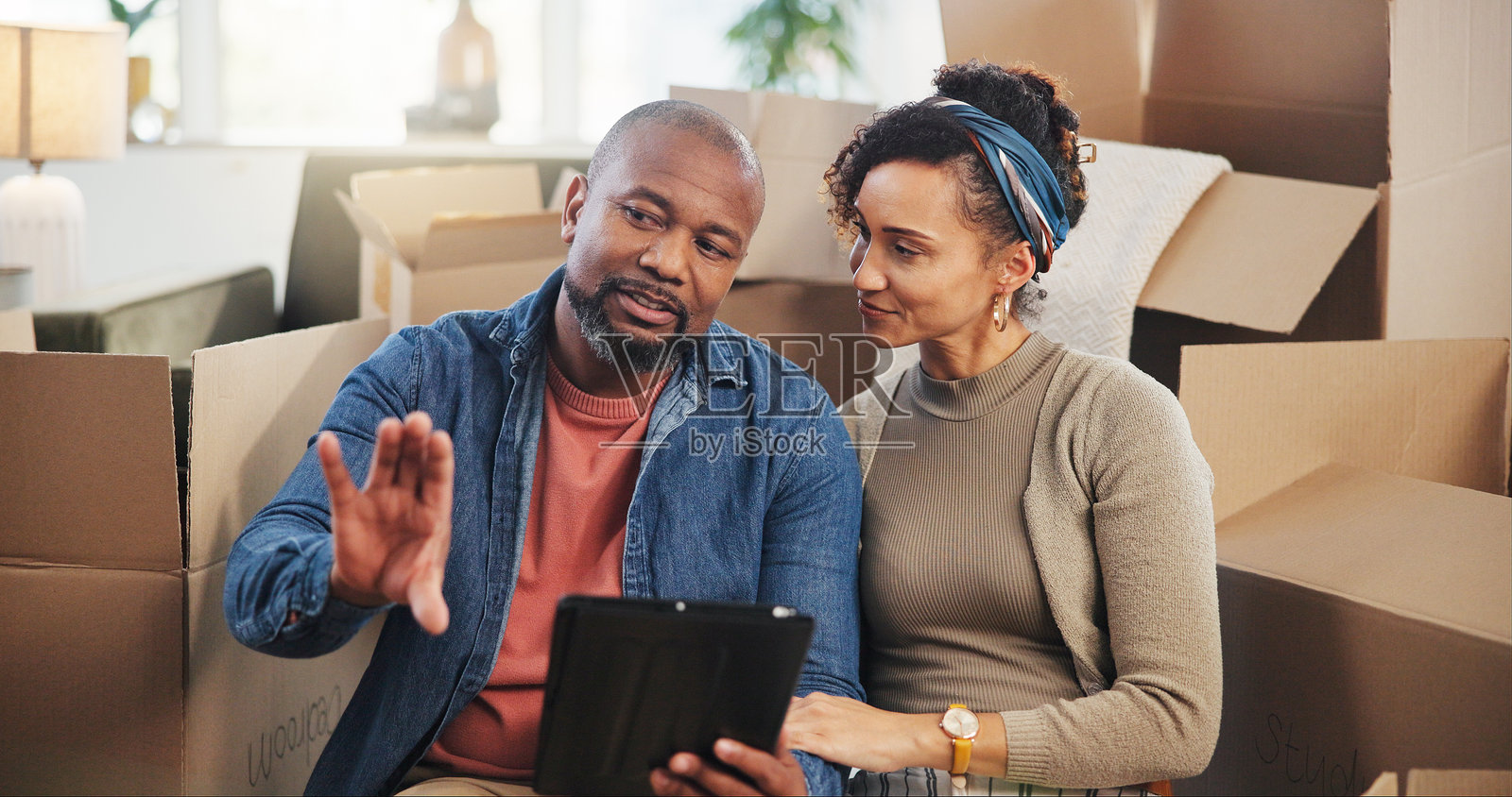 搬家，平板电脑和讨论的夫妇在新房子装修，数字布局或抵押。快乐，规划，房地产投资和盒子与男人和女人为房地产购买照片摄影图片