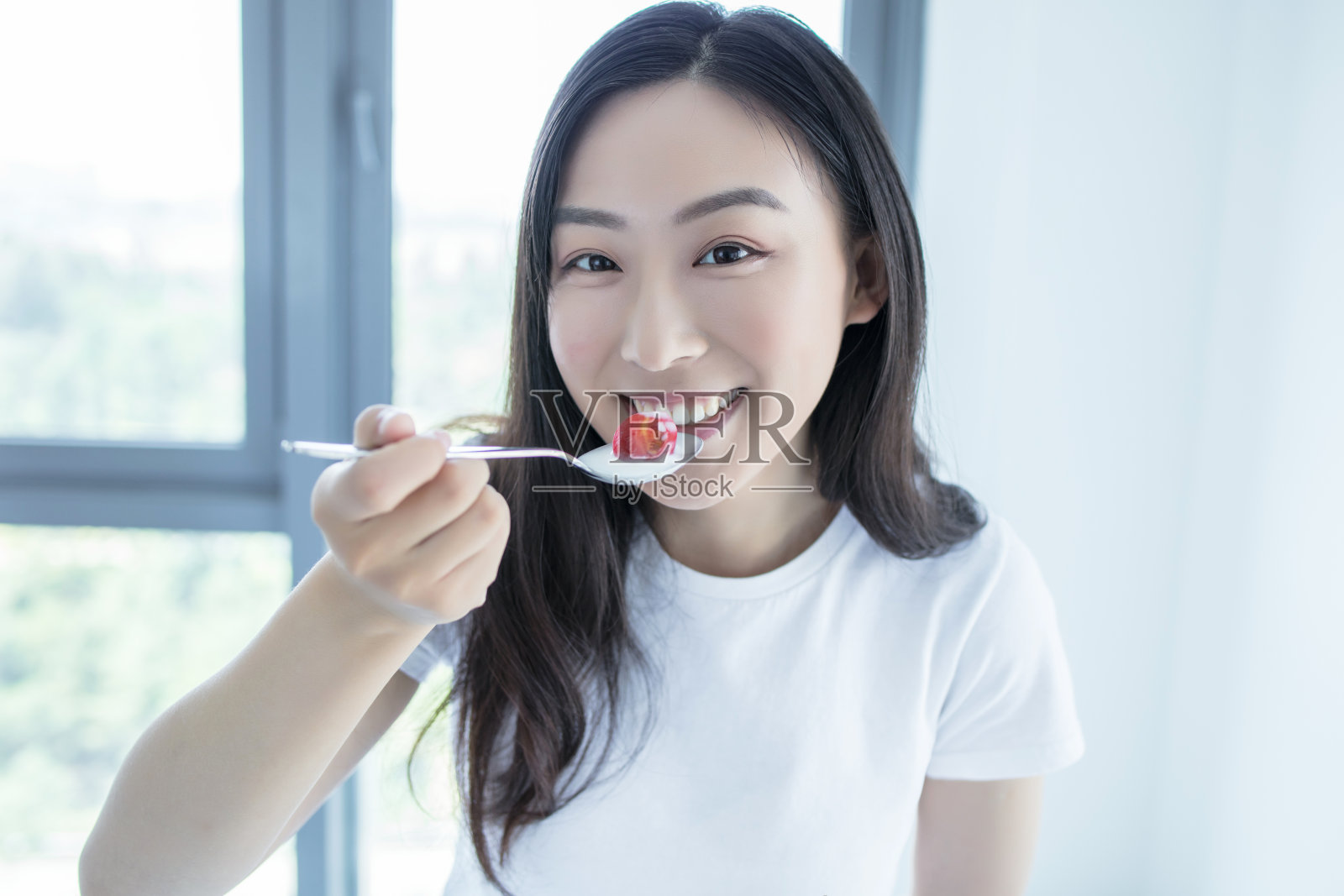 健康饮食，素食，饮食和人的概念-妇女的手与酸奶和浆果在桌子上的特写照片摄影图片