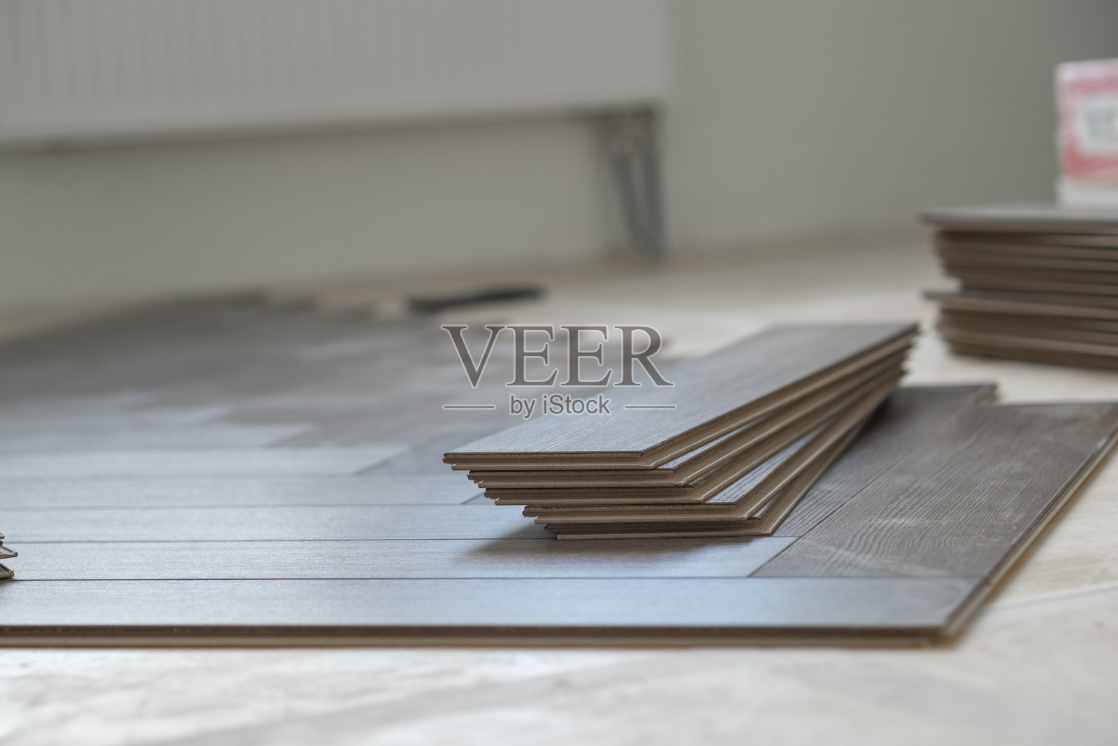 手工艺人在住宅公寓中安装复合地板。逐步进行。照片摄影图片