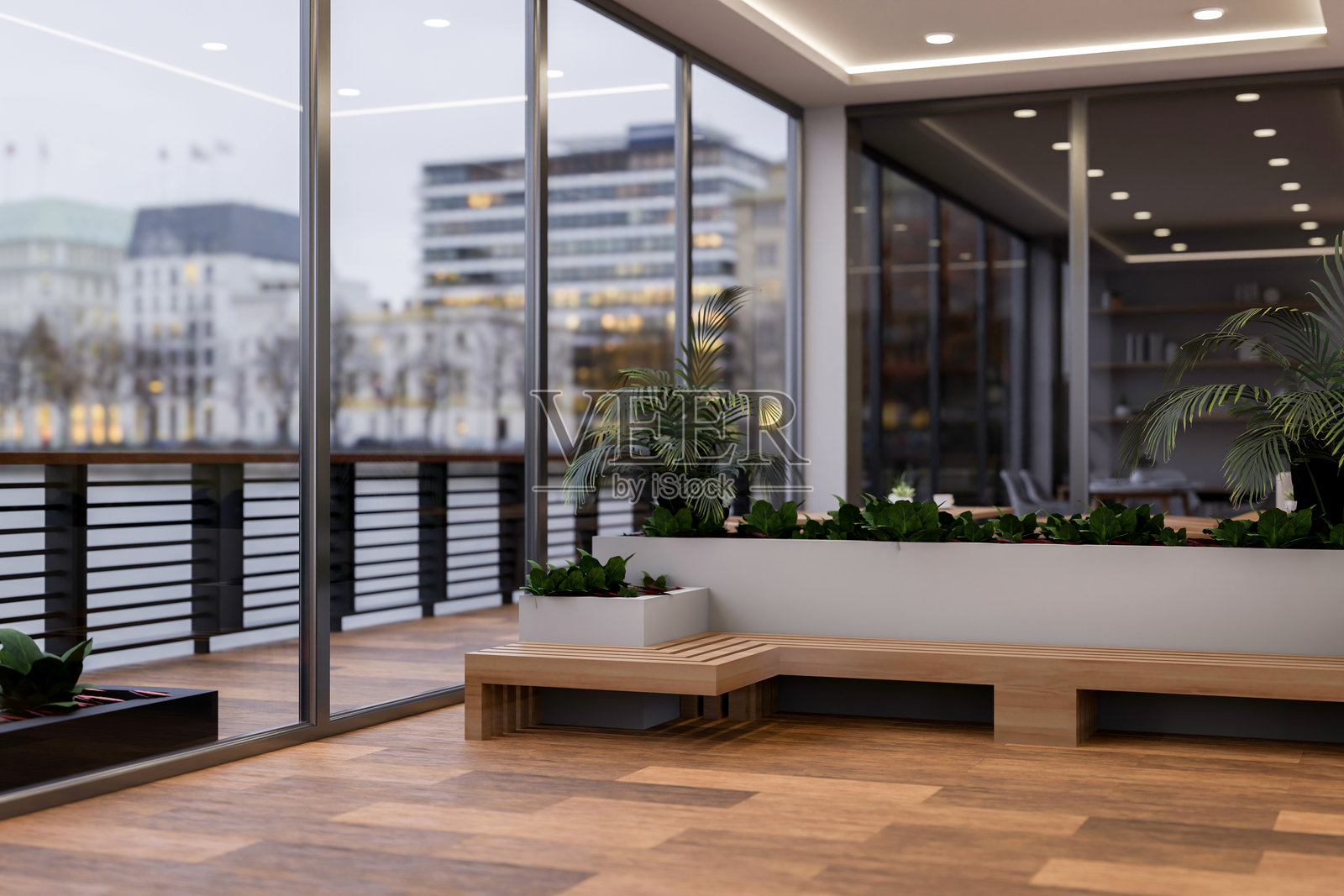 一座现代豪华的摩天大楼办公室设有一个带花园和长椅的室内休闲区。照片摄影图片