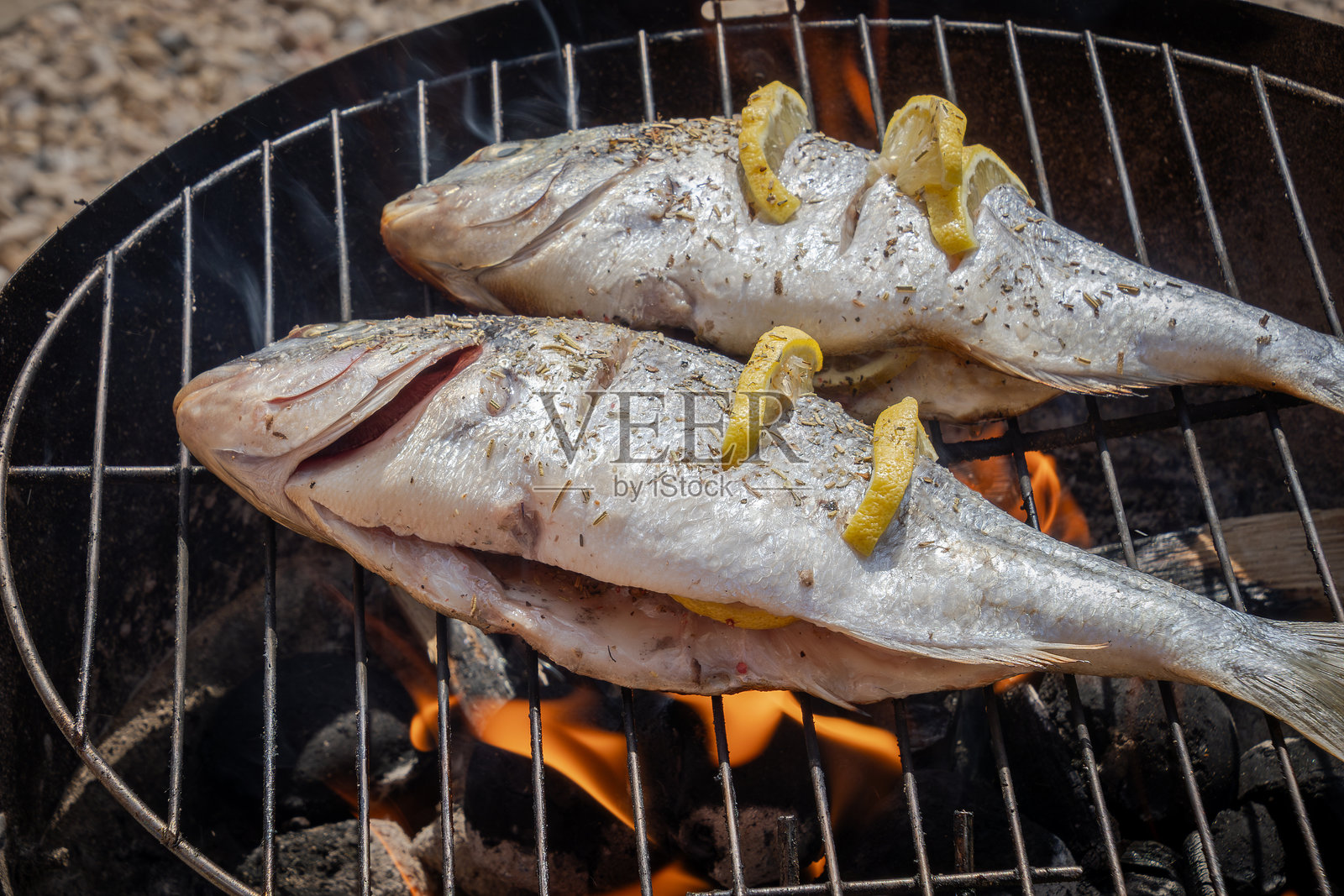 在烧烤架上烹饪海鲷鱼照片摄影图片