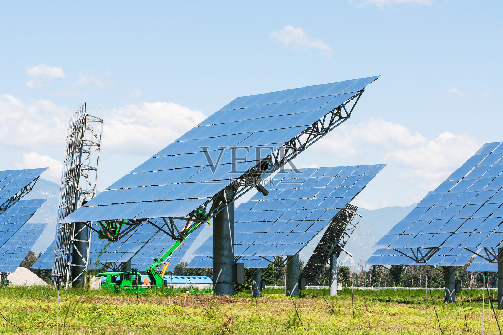 草地上光伏太阳能发电站照片摄影图片