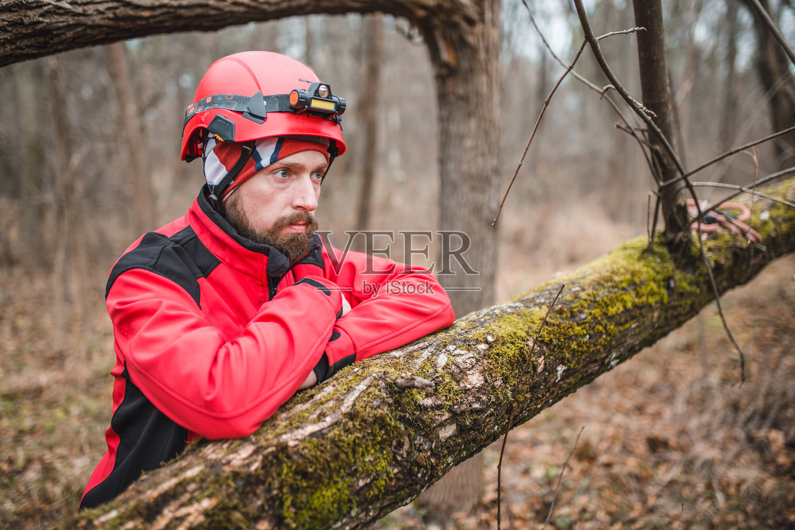 一名身穿制服的严肃山地救援人员在森林中等待救援行动。照片摄影图片