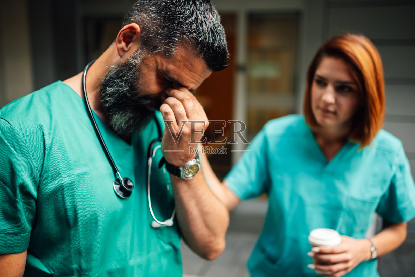 护士在医院入口处支持一位处于困境中的医生照片摄影图片