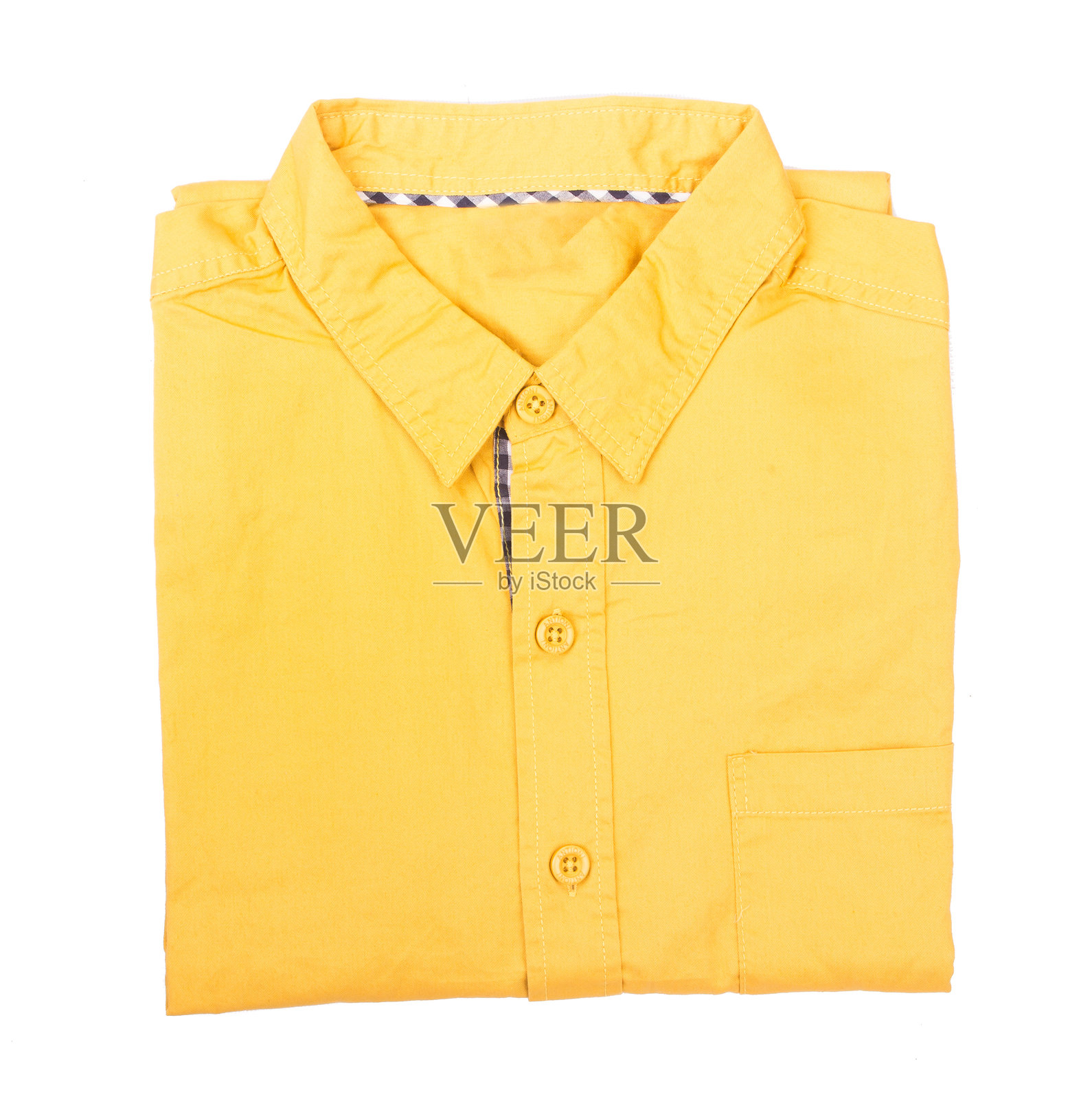 黄色折叠衬衫特写，背景为白色照片摄影图片