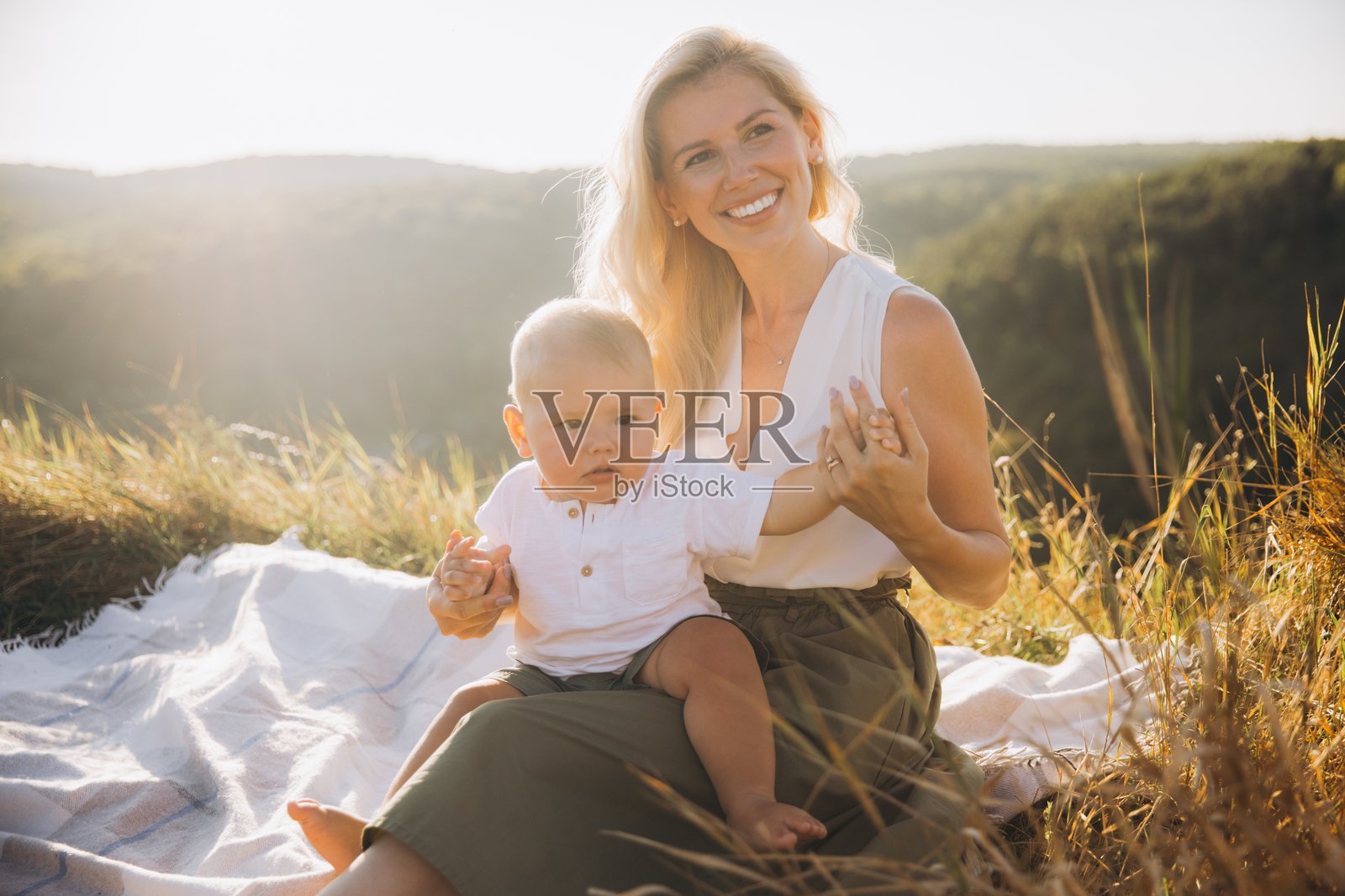 母亲和宝宝在美丽的自然环境中享受阳光明媚的野餐照片摄影图片