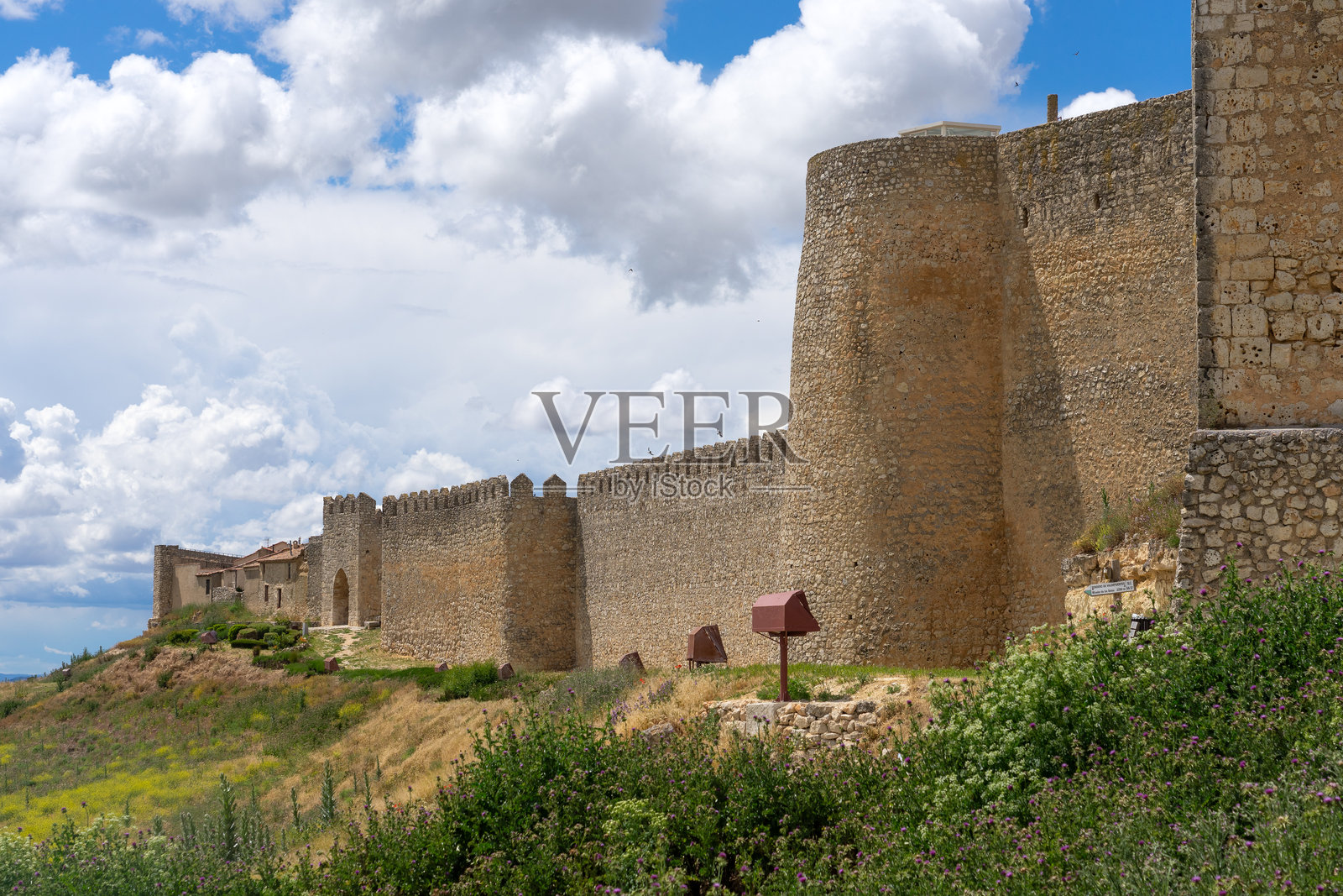 乌鲁埃纳村的中世纪城墙全景，春天的绿田环绕着这个书籍村庄。照片摄影图片