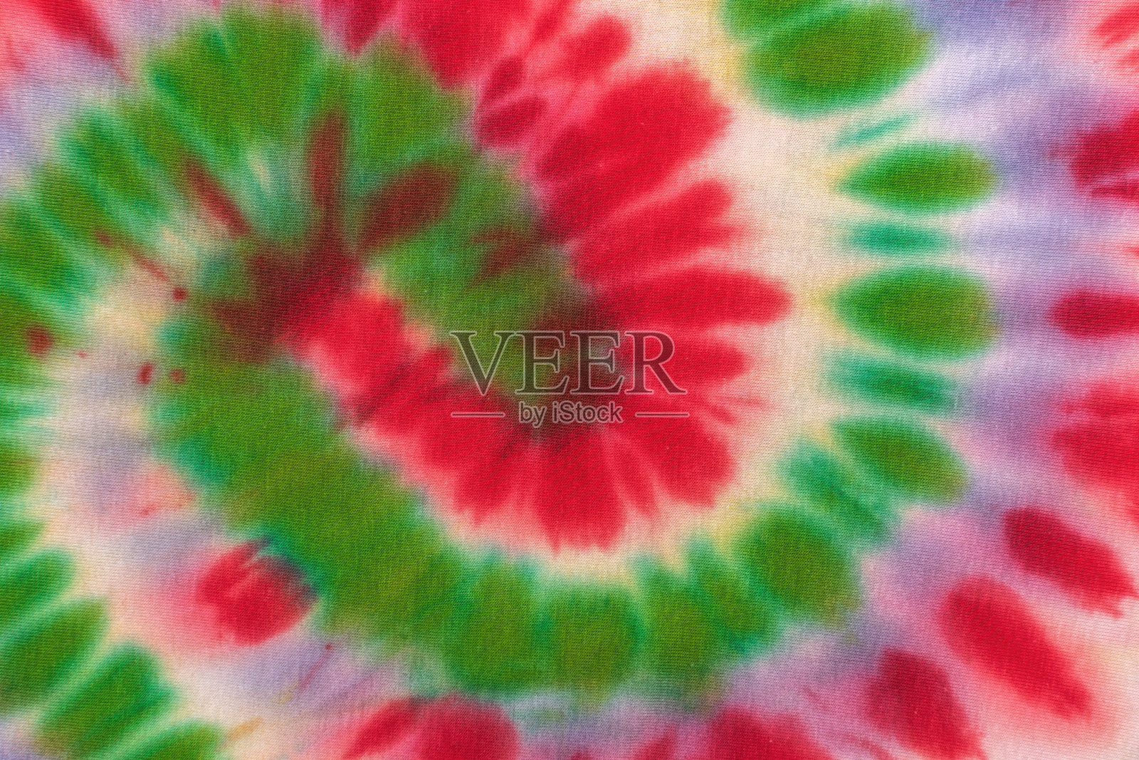 色彩缤纷的扎染图案，鲜艳的红色、绿色和紫色螺旋设计照片摄影图片