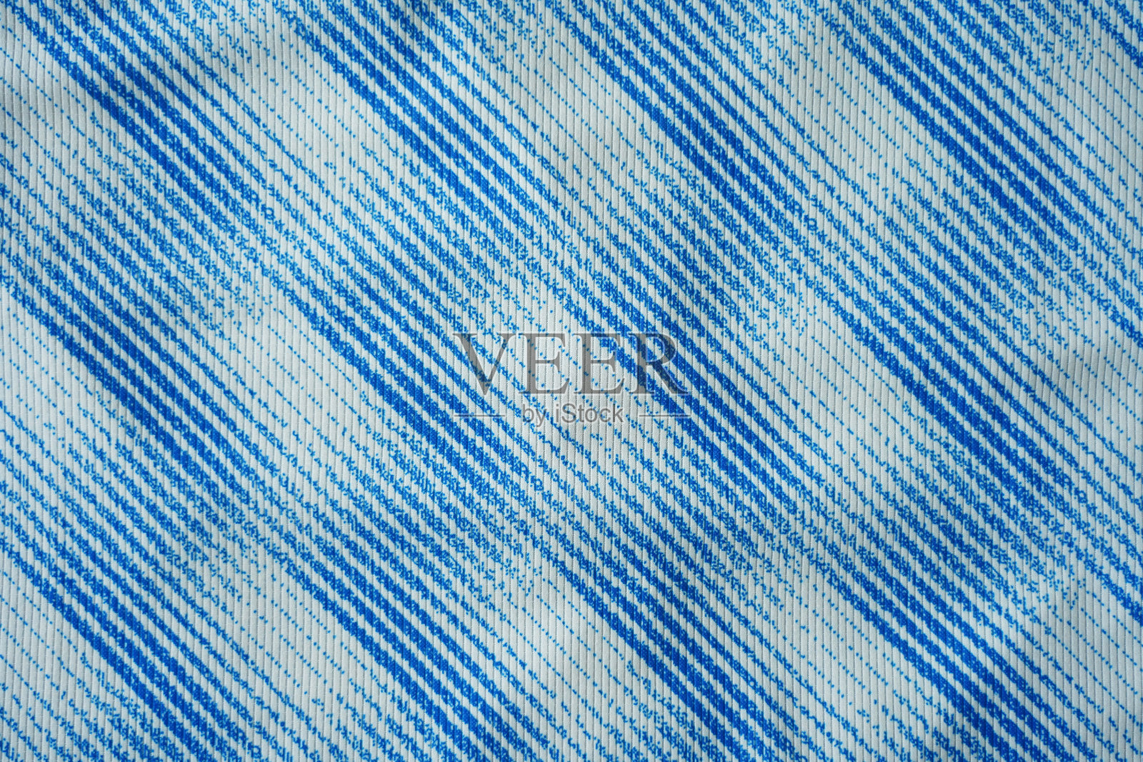 蓝色足球球衣运动服面料纹理特写。照片摄影图片