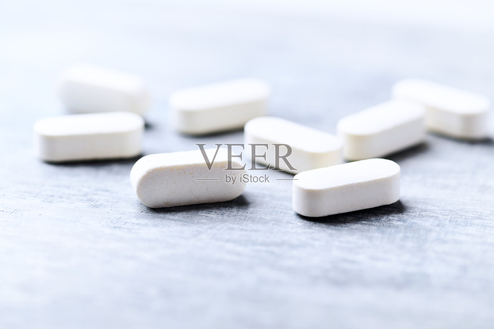 亮色木质背景上的氨基酸健身补剂照片摄影图片