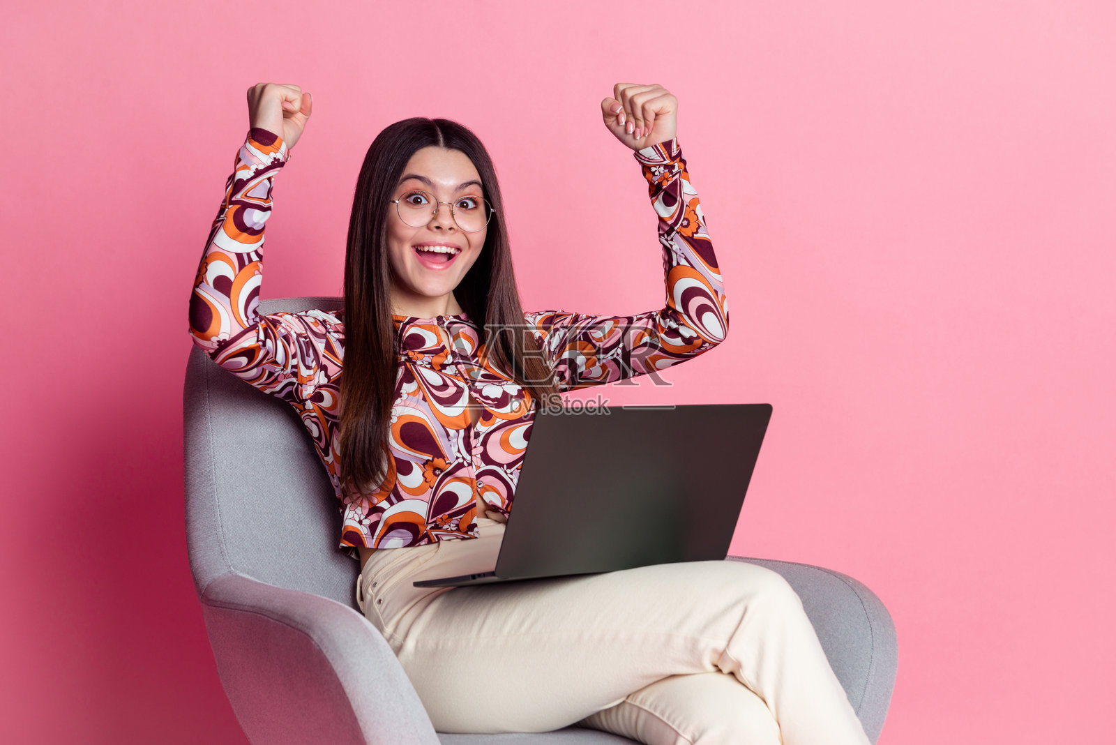 粉色背景，拉丁裔棕发少女身穿时尚衬衫，赢得免费订阅课程照片摄影图片