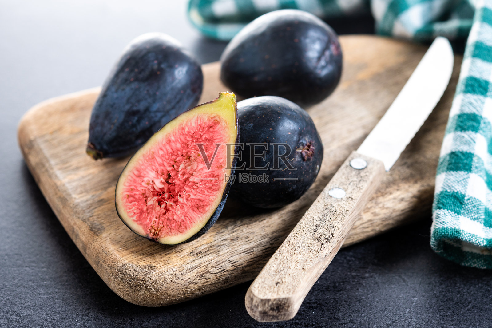 新鲜无花果在黑色石板背景上照片摄影图片