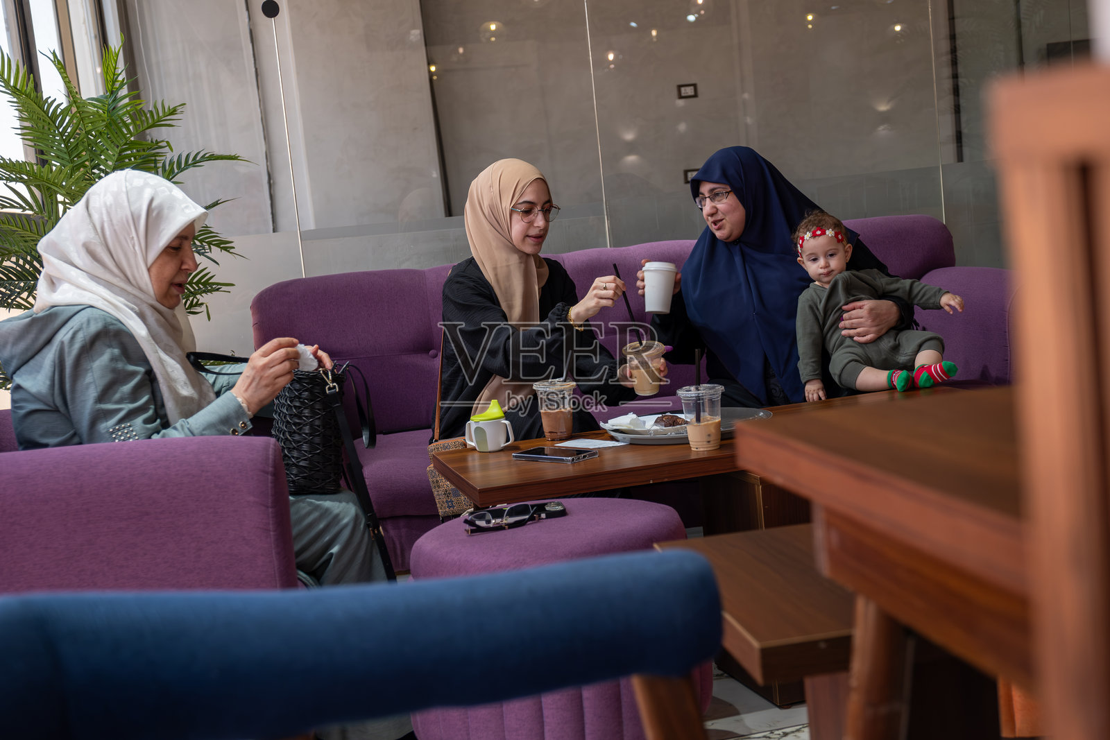 在现代咖啡馆享受咖啡和交谈的妇女照片摄影图片