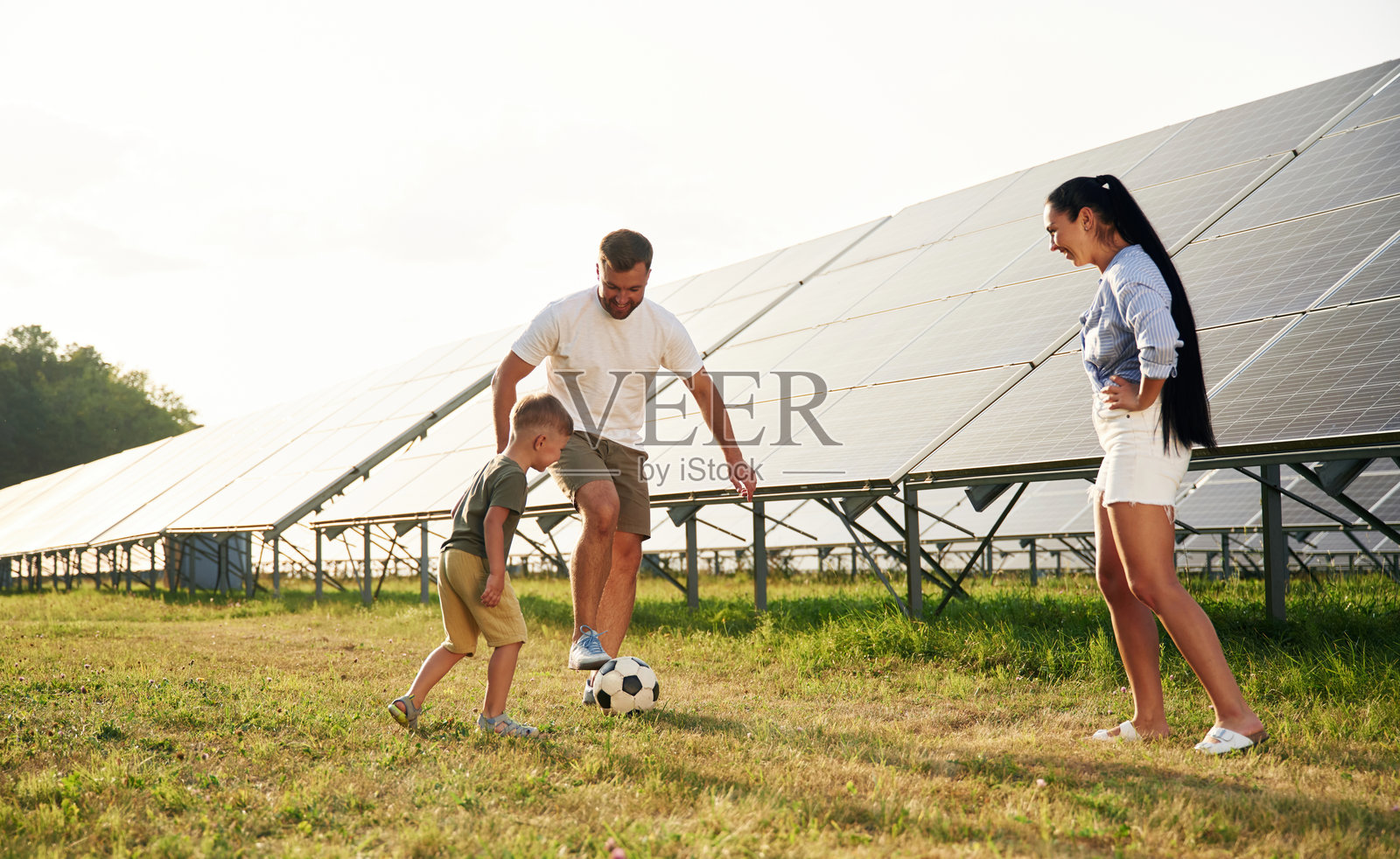 父亲、母亲和小儿子在户外太阳能电池板附近照片摄影图片