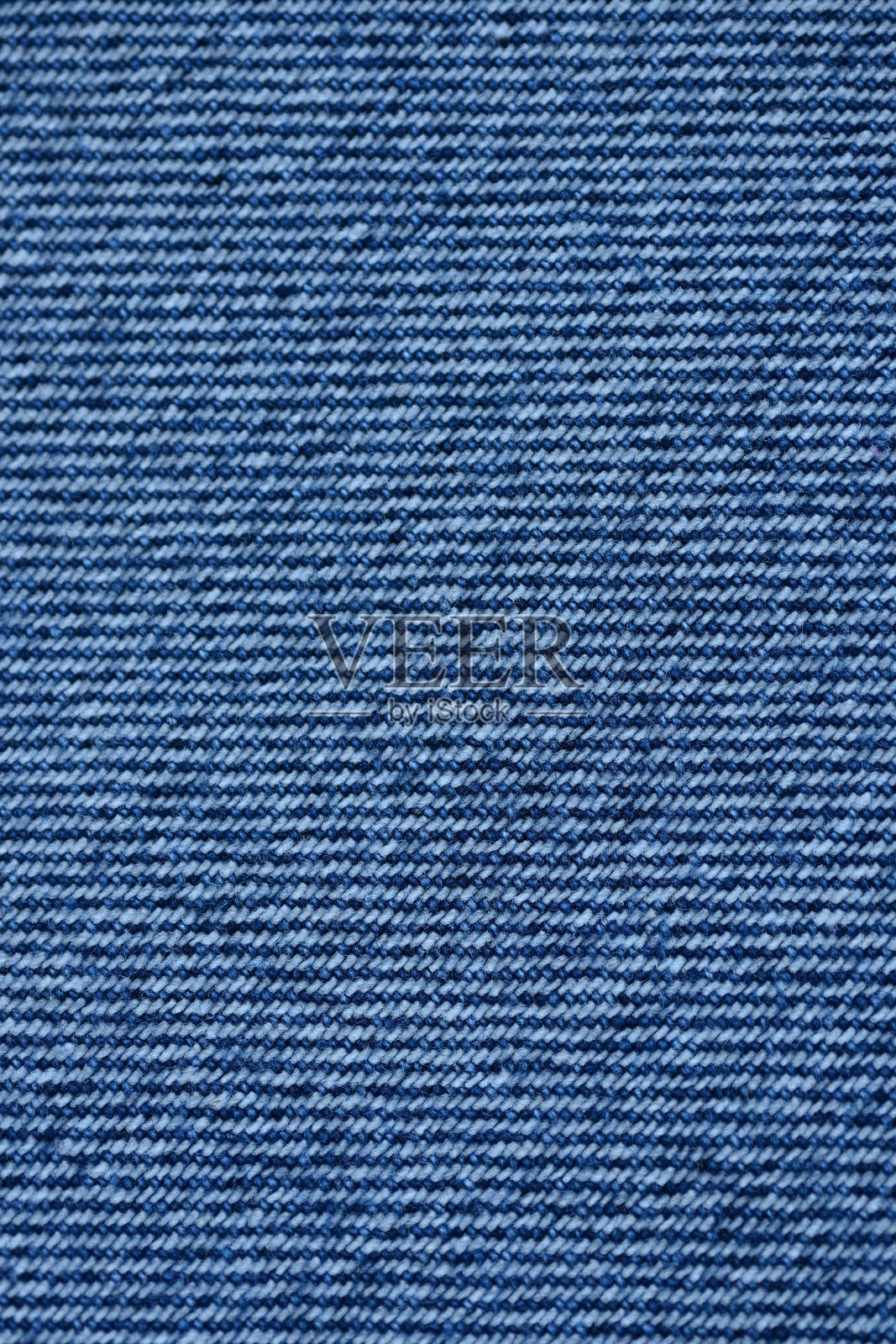 宏观蓝色牛仔布纹理，蓝色牛仔布纹理作为背景的特写照片，从上方拍摄。照片摄影图片