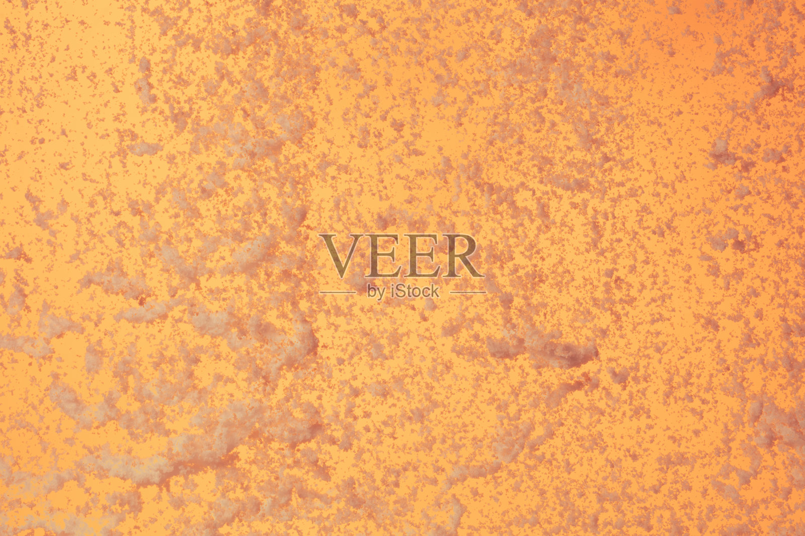 冬季雪花在橙色晚霞的天空中飞舞。阳光下，雪尘在橙色的黄昏中飘洒，背景为黄色。照片摄影图片