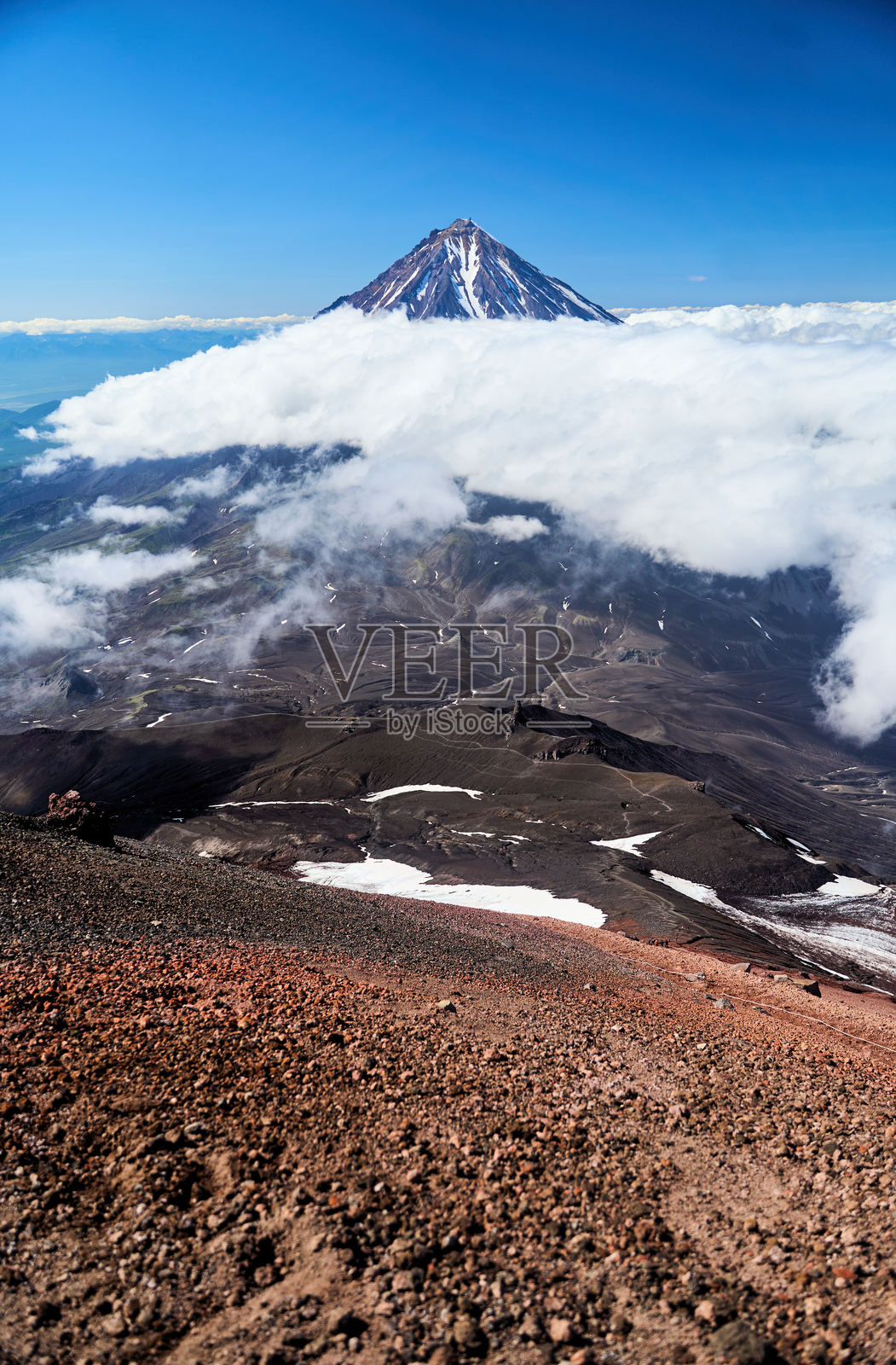 科里亚克火山。雄伟壮观的火山矗立在清澈明亮的蓝天之下。照片摄影图片