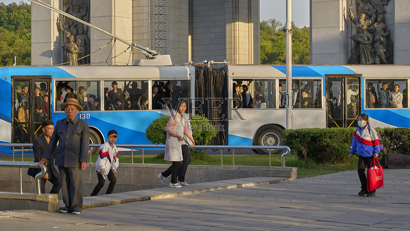 平壤居民漫步在凯旋门附近的广场上,凯旋门是一个历史地标,也是一个受欢迎的参观地点照片摄影图片