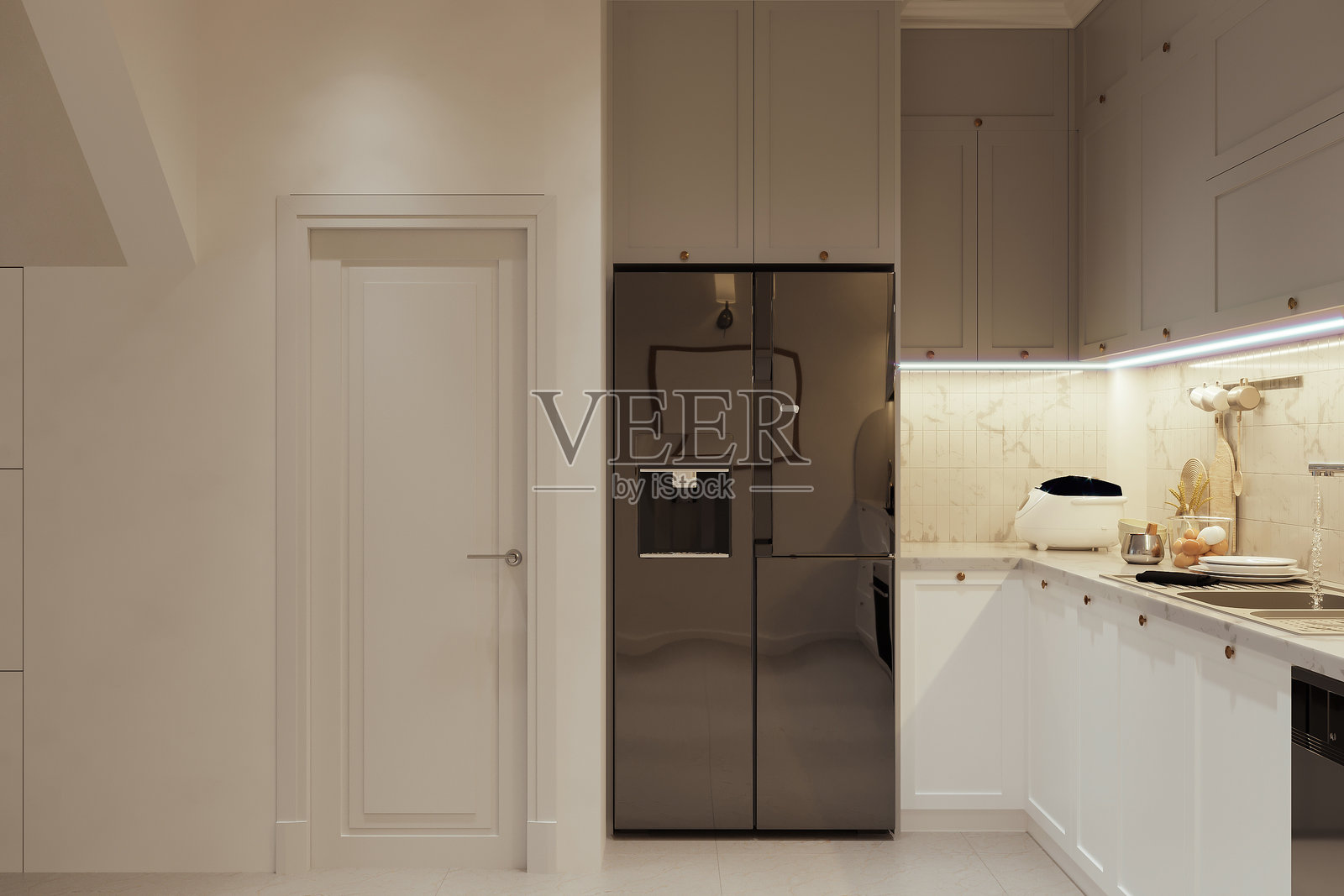 现代简约风格厨房，配有光滑的黑色冰箱和米色橱柜照片摄影图片