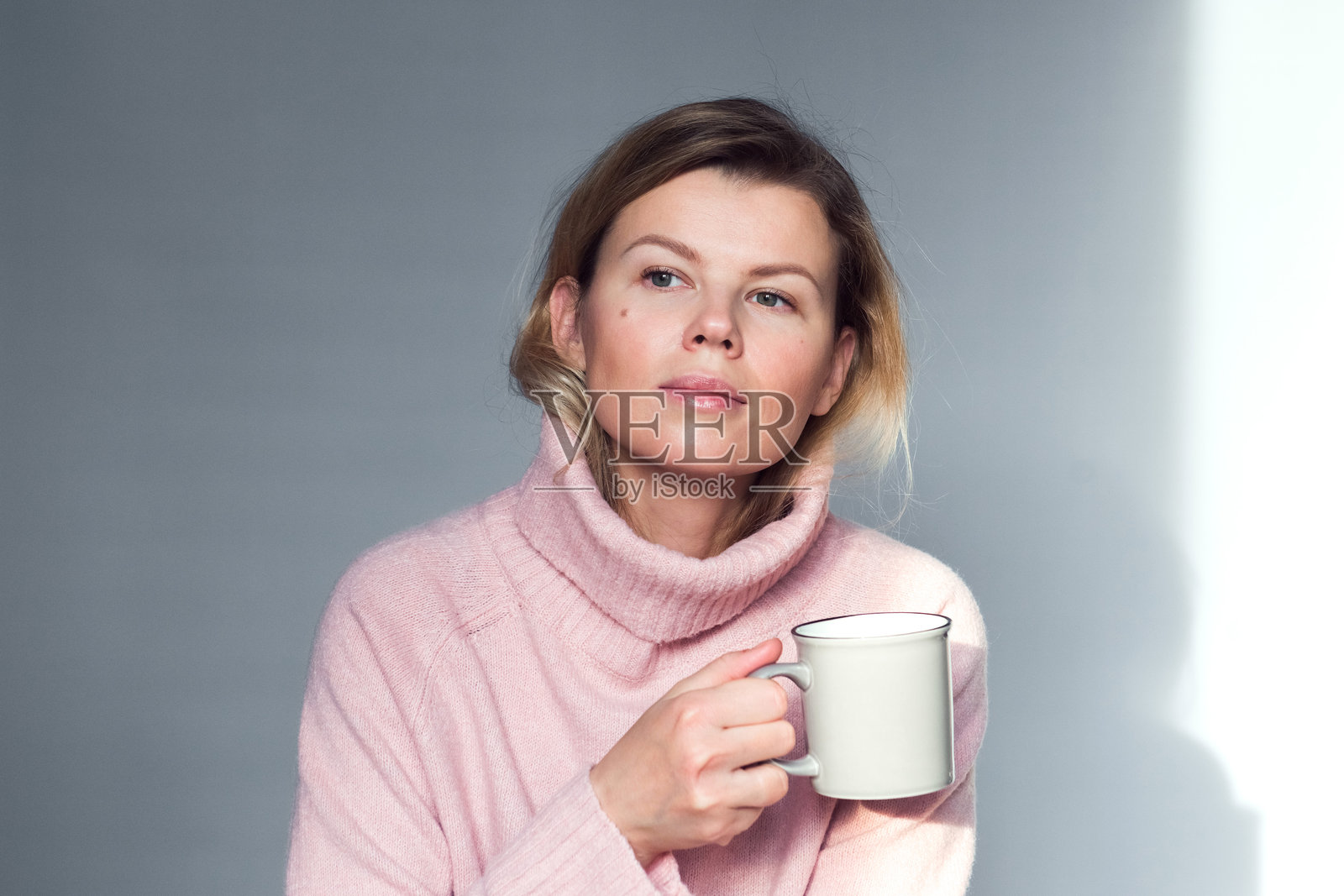 美丽的年轻女性手持茶杯或咖啡杯，室内生活方式肖像照片摄影图片