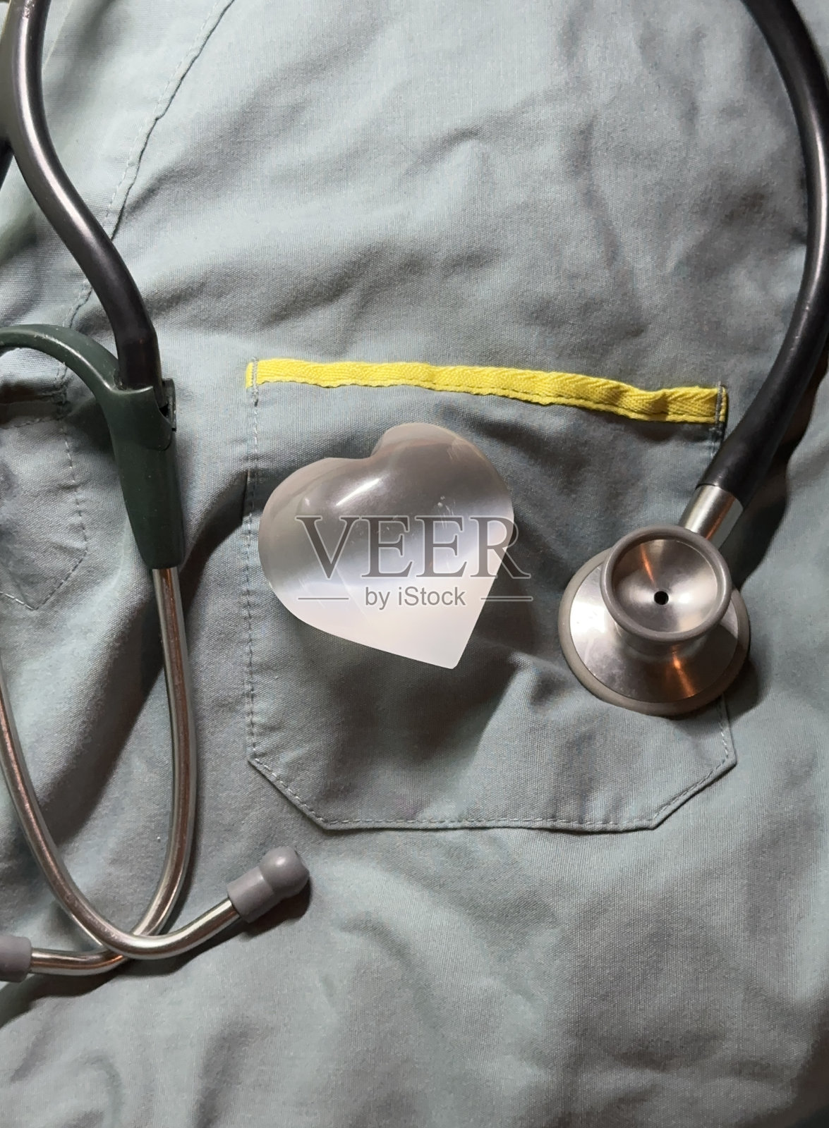 心形水晶听诊器（手术服背景）照片摄影图片