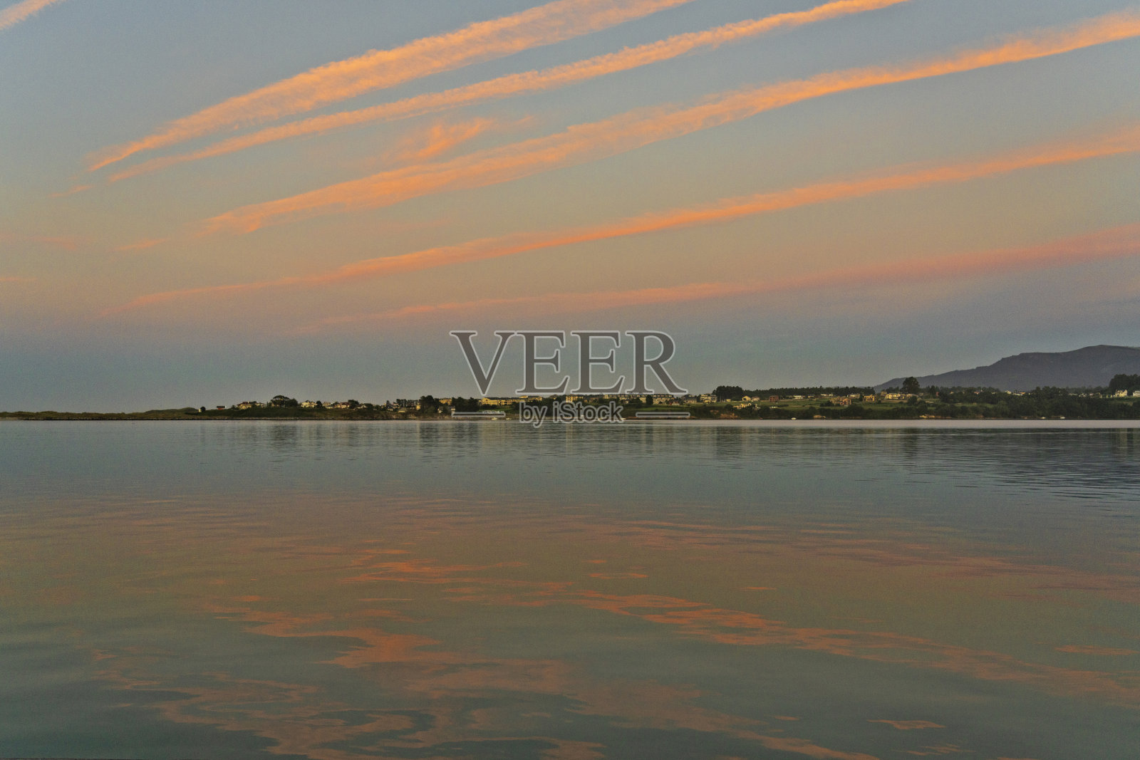 宁静的日落倒影映照在平静的水面上照片摄影图片