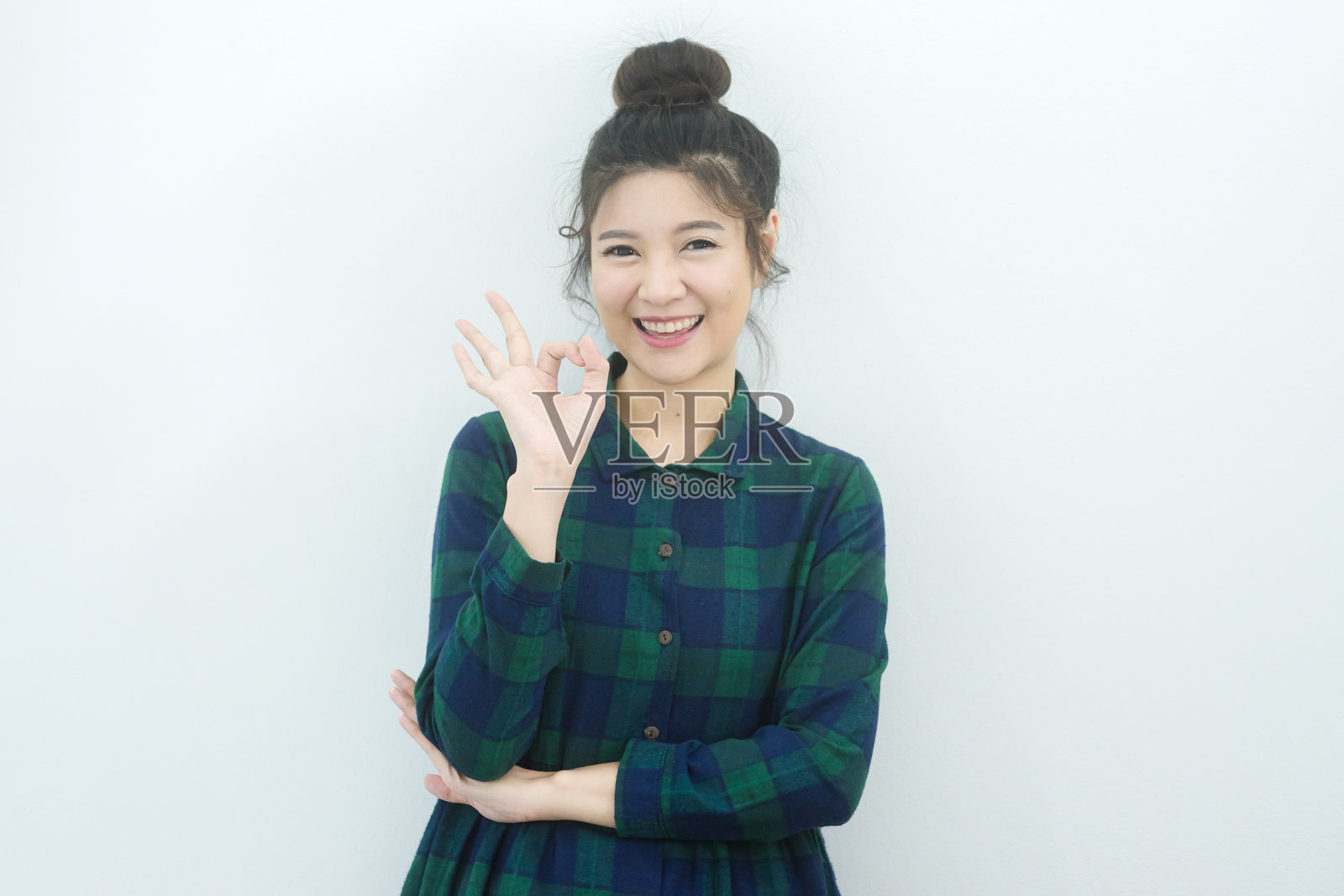 愉快女性在白色背景前做出“好”的手势照片摄影图片