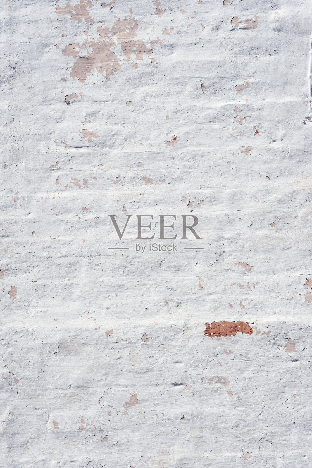 旧石膏的纹理。砖墙上的剥落石膏。抽象背景照片摄影图片