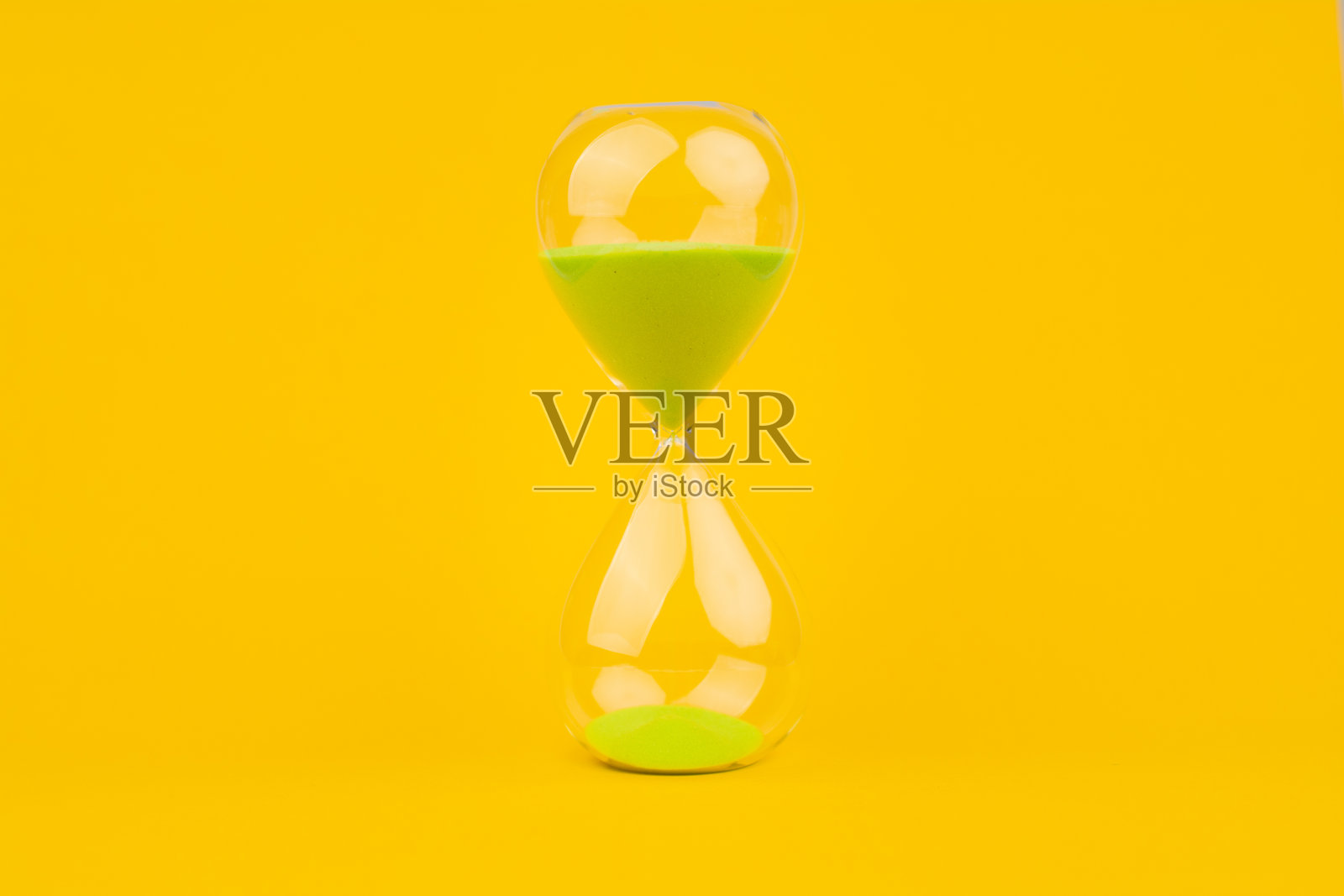 沙漏黄色背景，时间和倒计时时间限制的紧急工作，以满足最后期限和约会。照片摄影图片