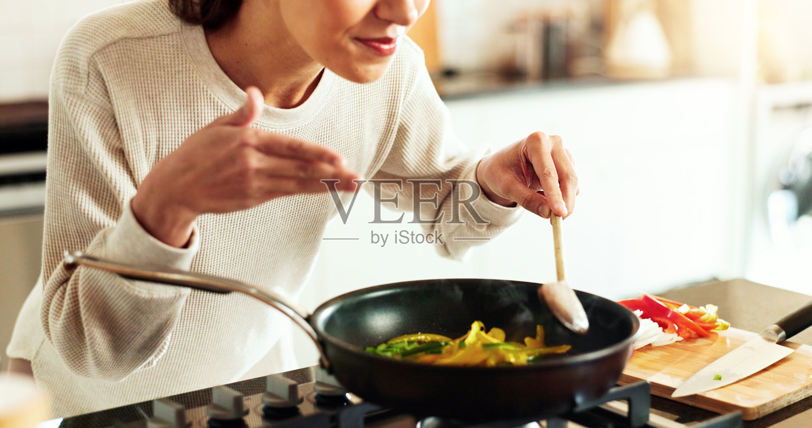 女性厨师在厨房中使用香料和煎锅，为饮食或食谱带来满足感。女性正在烹饪，创造美食，作为营养师进行餐点准备、晚餐或食品制作。照片摄影图片