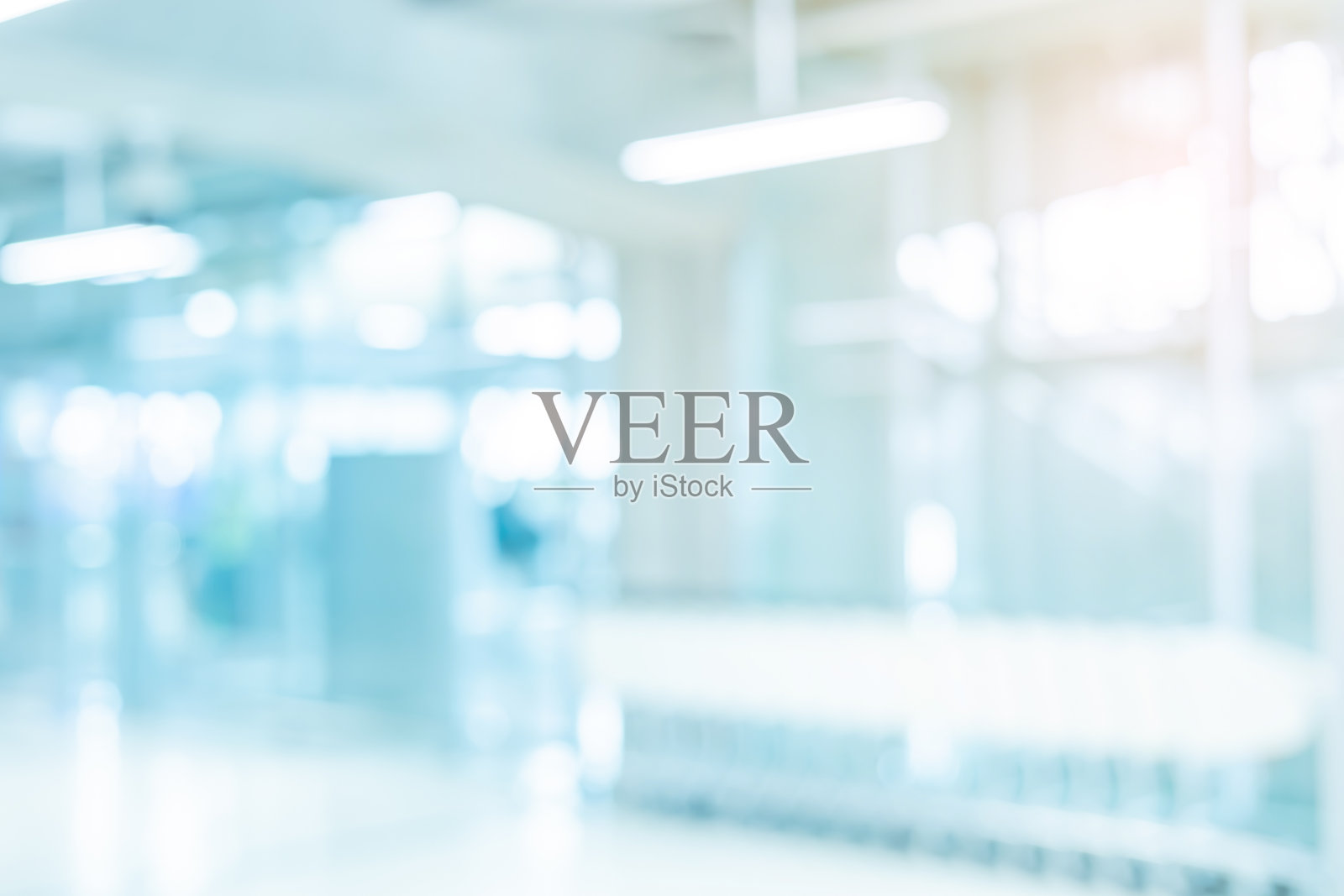 医院建筑内部模糊的抽象背景，带有光线闪耀，适用于广告设计和展示内容概念照片摄影图片