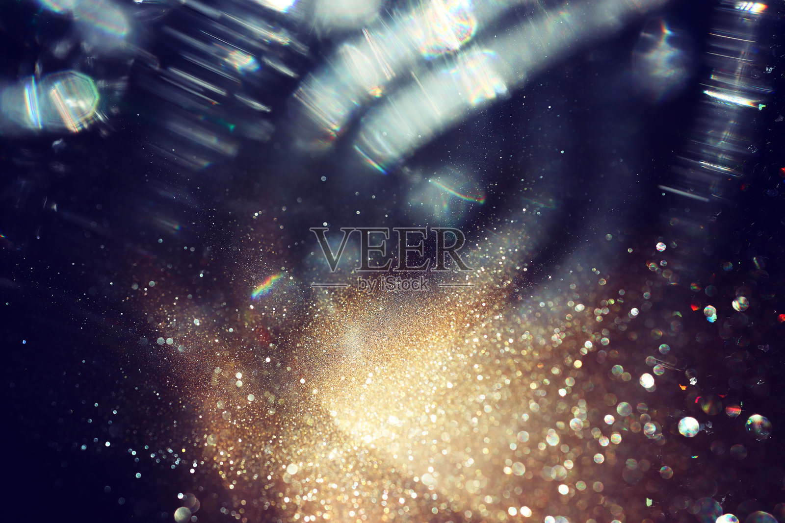 抽象的金色和黑色闪光灯背景，虚化效果。照片摄影图片