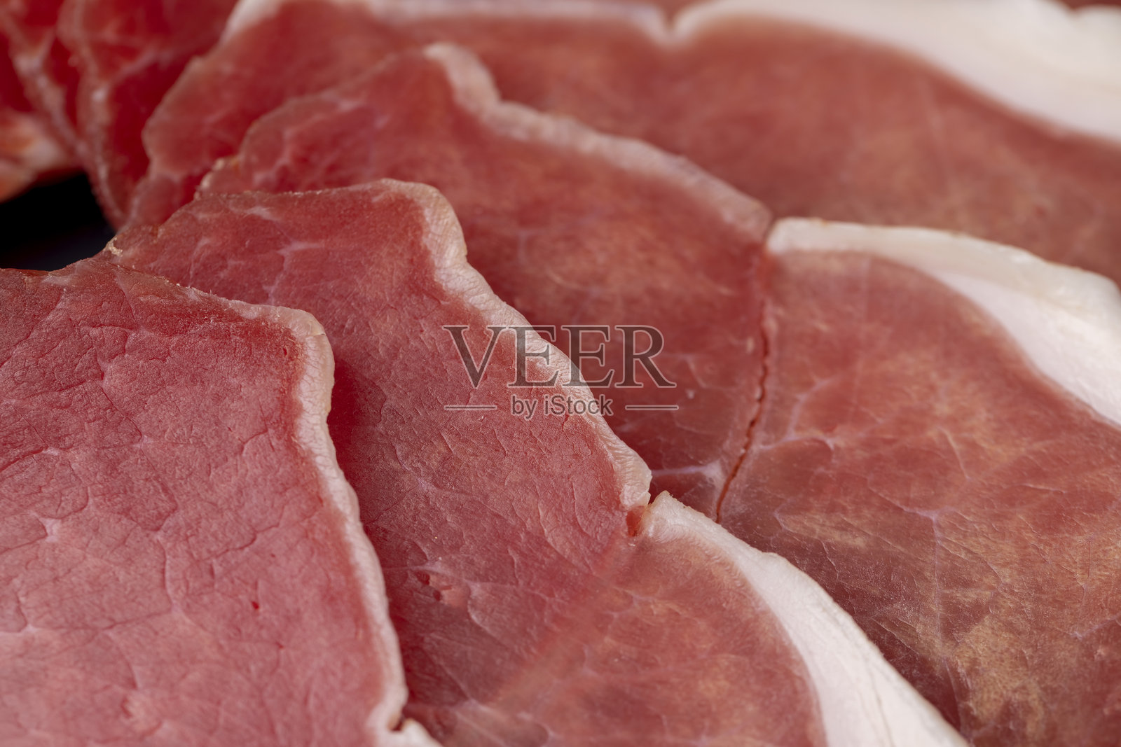 切片火腿与培根放在砧板上照片摄影图片