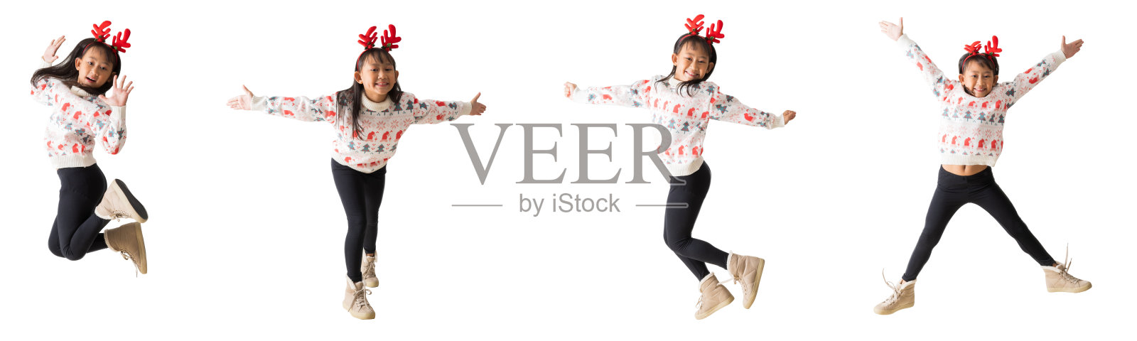 一组亚洲小女孩穿着带有驯鹿角的圣诞毛衣，开心地微笑庆祝成功，跳舞并举手摆姿势的全身肖像，背景为白色，适合设计工作的抠图路径。照片摄影图片