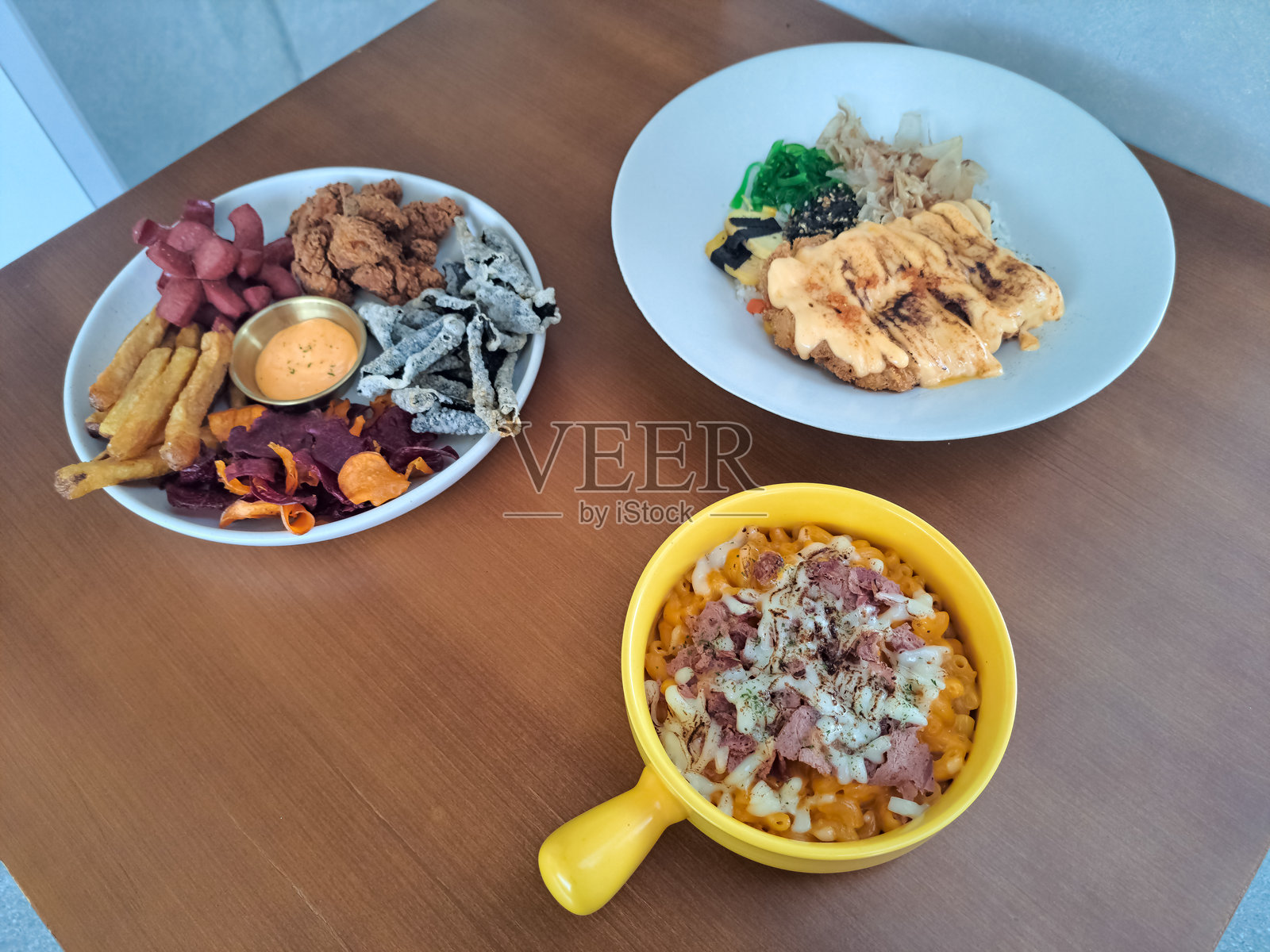 通心粉奶酪、香肠小吃拼盘、手切薯条、土豆片、海苔片、炸鸡和脆皮明太子鸡。菜单。照片摄影图片