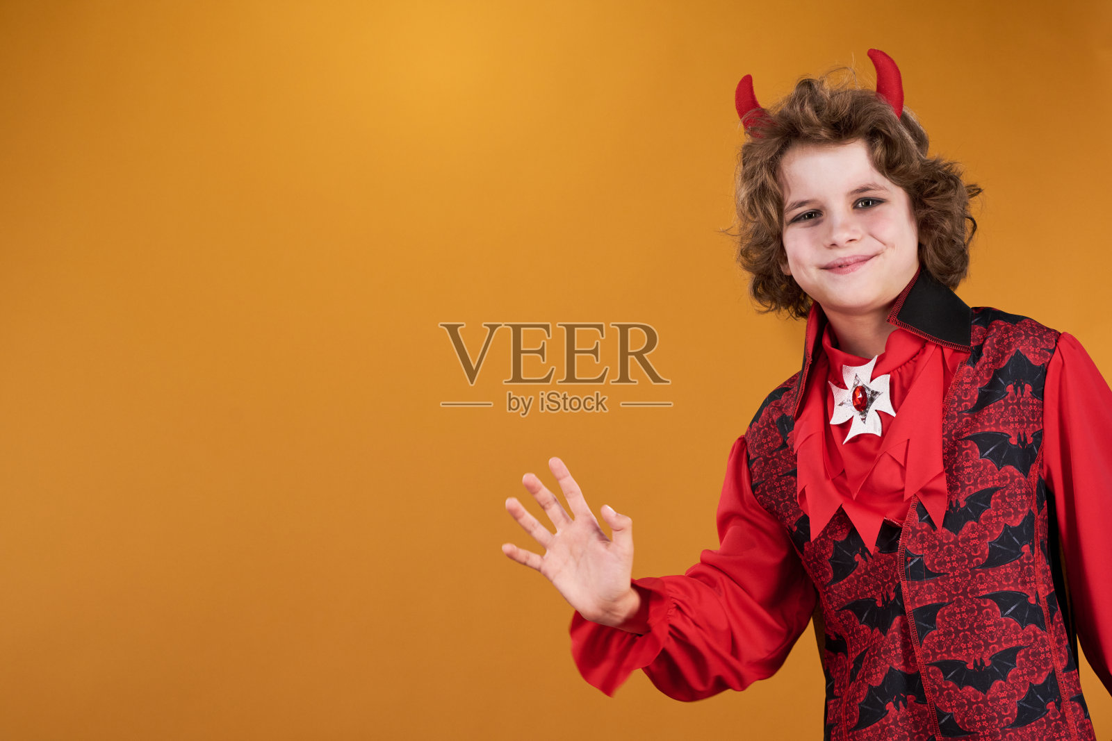 微笑的男孩穿着服装挥手照片摄影图片