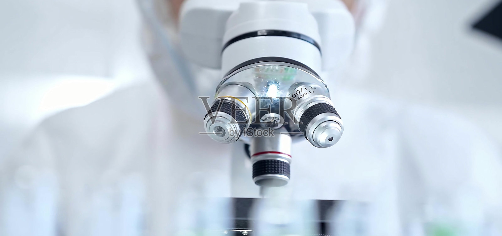 专业科学家穿着防护装备在实验室环境中使用显微镜，特写。科学和医学概念照片摄影图片