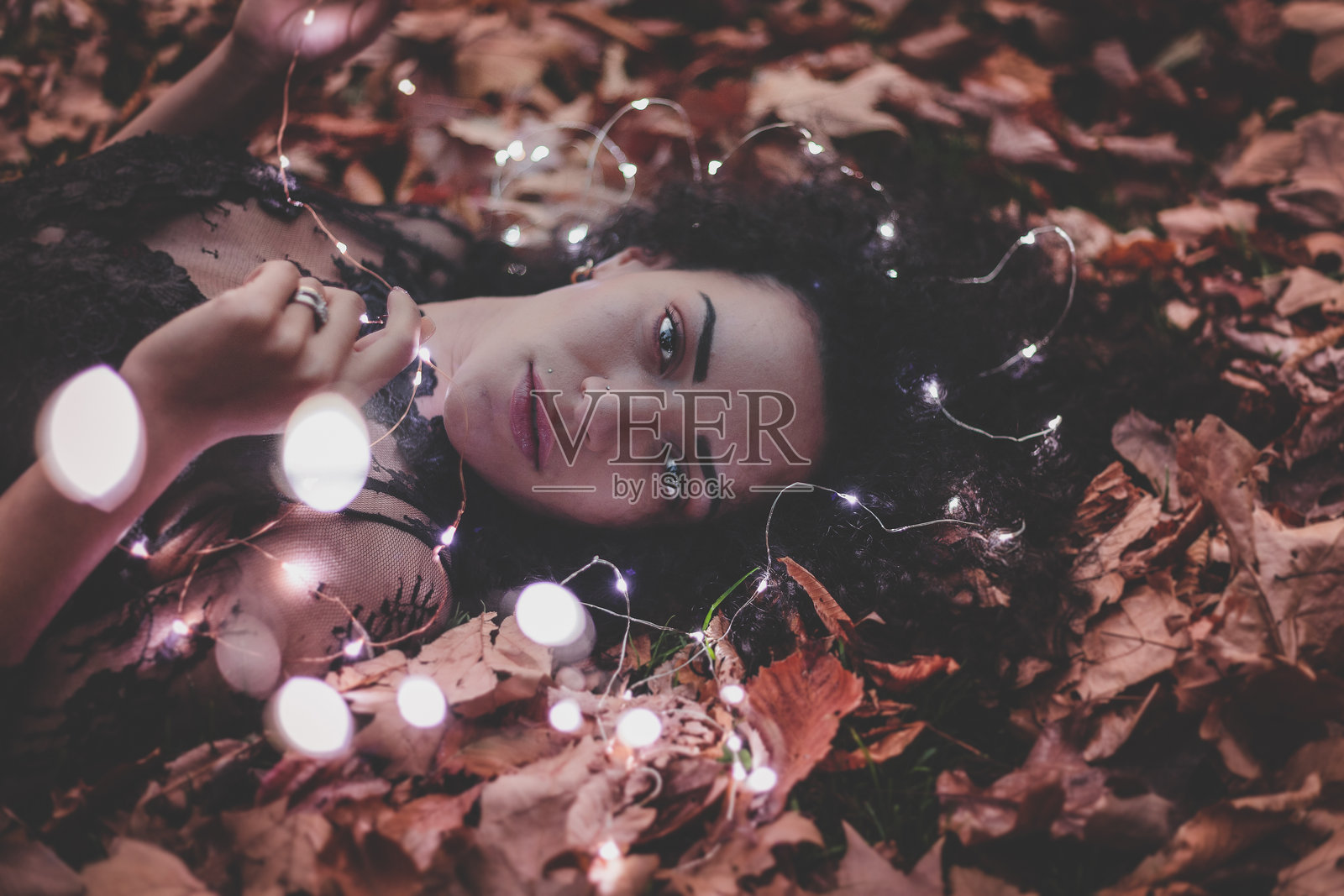 秋天公园里躺在草地上的年轻女性肖像照片摄影图片