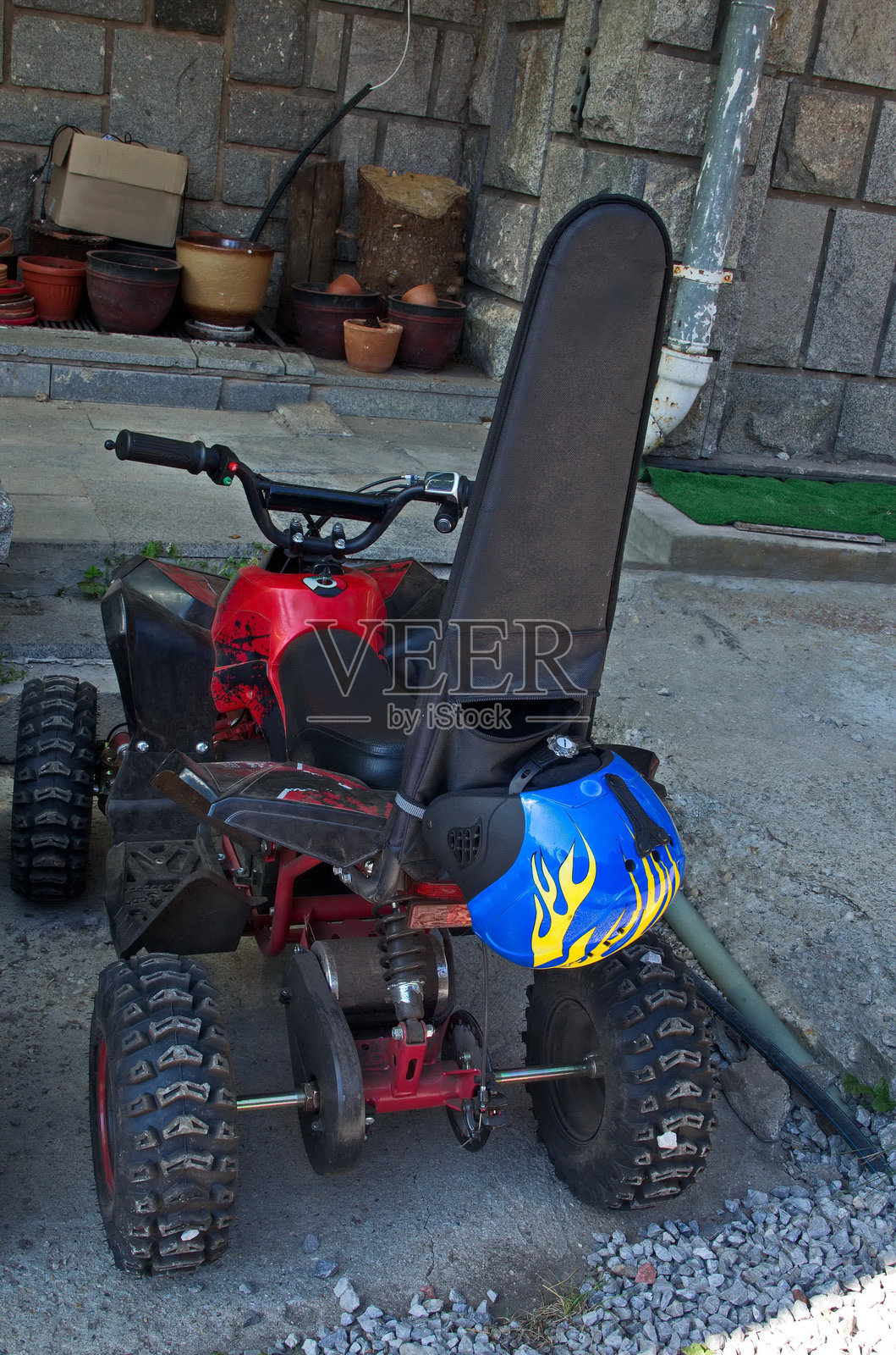 红色滑板车停在黑峰脚下的维托沙山旁边的人行道上，靠近栅栏。照片摄影图片