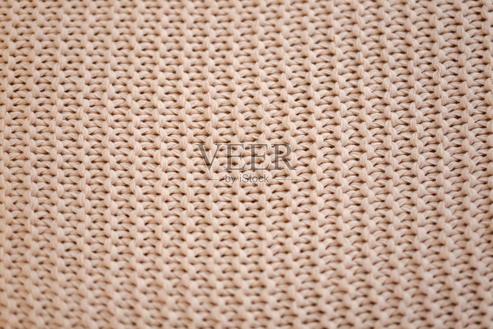 一块带有白色背景的针织面料特写照片摄影图片