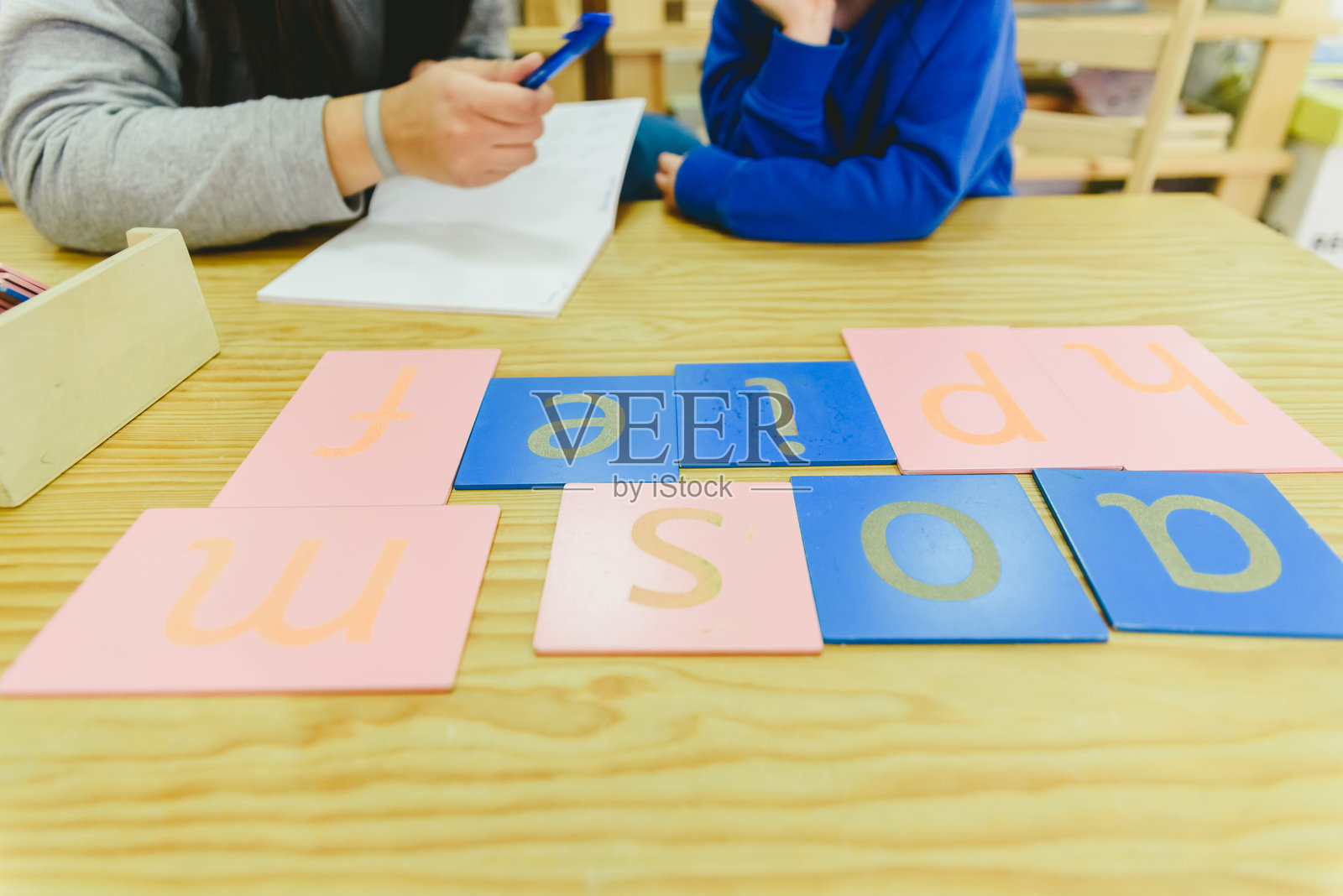 坐在学校里的女性与学生的中部特写照片摄影图片