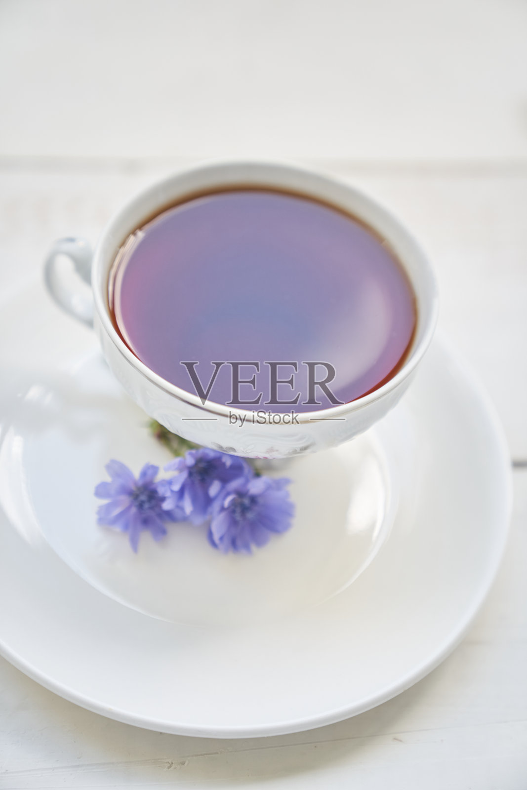 美味的菊苣饮料，木桌上摆放着杯子和碟子，旁边有一个可以写字的地方。这是一种由菊苣制成的健康饮品。照片摄影图片